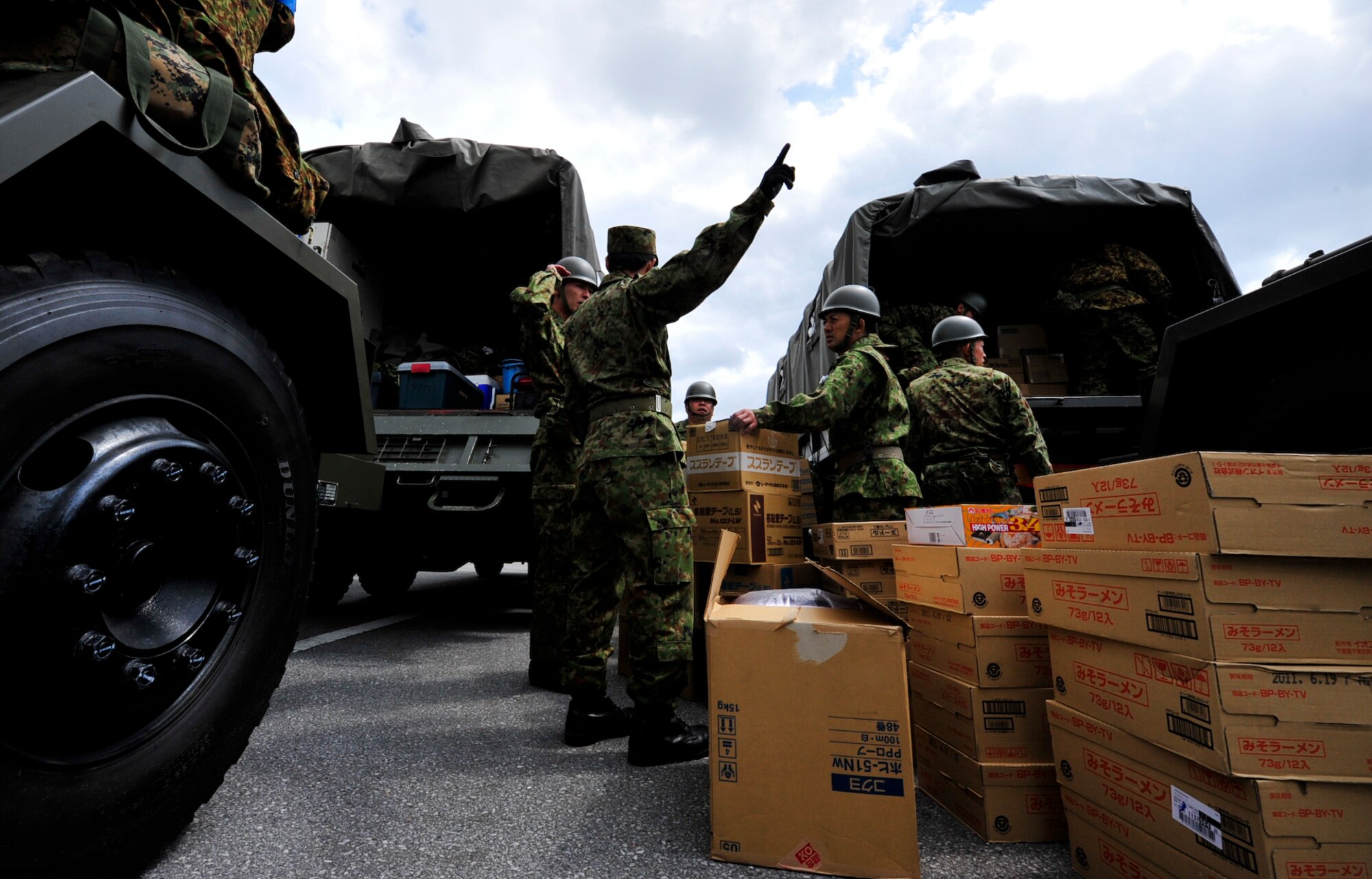 Members of the 15 Brigade, Japan Ground Self Defense Force load and prepare supplies on trucks headed to mainland Japan March 16. Teams from the 15 Brigade, JGSDF along with thousands of pounds of supplies are heading to northern Japan to aid earthquake and tsunami victims. Hundreds of Airmen, thousands of pounds of relief supply and many U.S. aircrafts have been sent to northern Japan from Kadena as well.  (U.S. Air Force photos/Senior Airman Sara Csurilla)