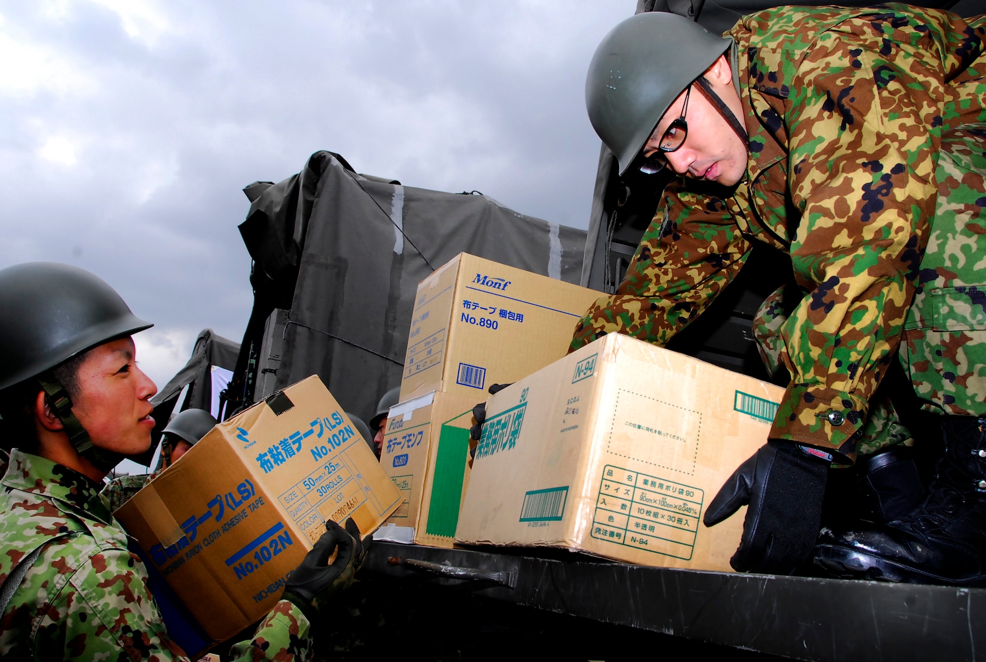 Members of the 15 Brigade, Japan Ground Self Defense Force load and prepare supplies on trucks headed to mainland Japan March 16. Teams from the 15 Brigade, JGSDF are heading to northern Japan to aid earthquake and tsunami victims with trucks loaded with supplies including clothes, blankets and toiletries. Hundreds of Airmen, thousands of pounds of relief supply and many U.S. aircrafts have been sent to northern Japan from Kadena as well. (U.S. Air Force photos/Airman 1st Class Maeson Elleman)