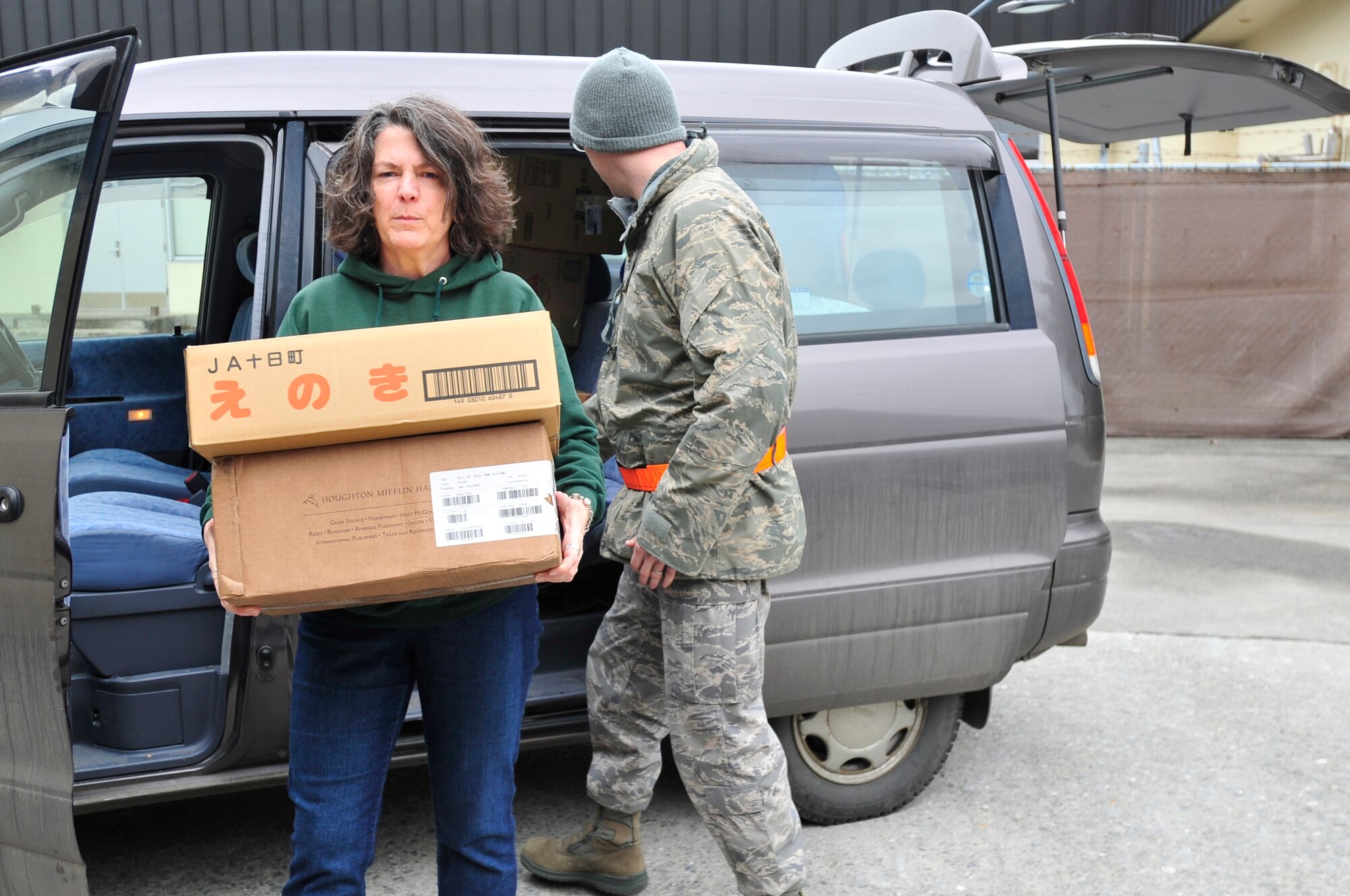 MISAWA AIR BASE, Japan -- Amy Sweeney, unloads boxes of donated items from her car Mar. 15. A collection point was set up at Edgren High School for residents to drop off clothes, jackets, blankets and non-perishable food items. (U.S. Air Force photo by Staff Sgt. Marie Brown\Released)