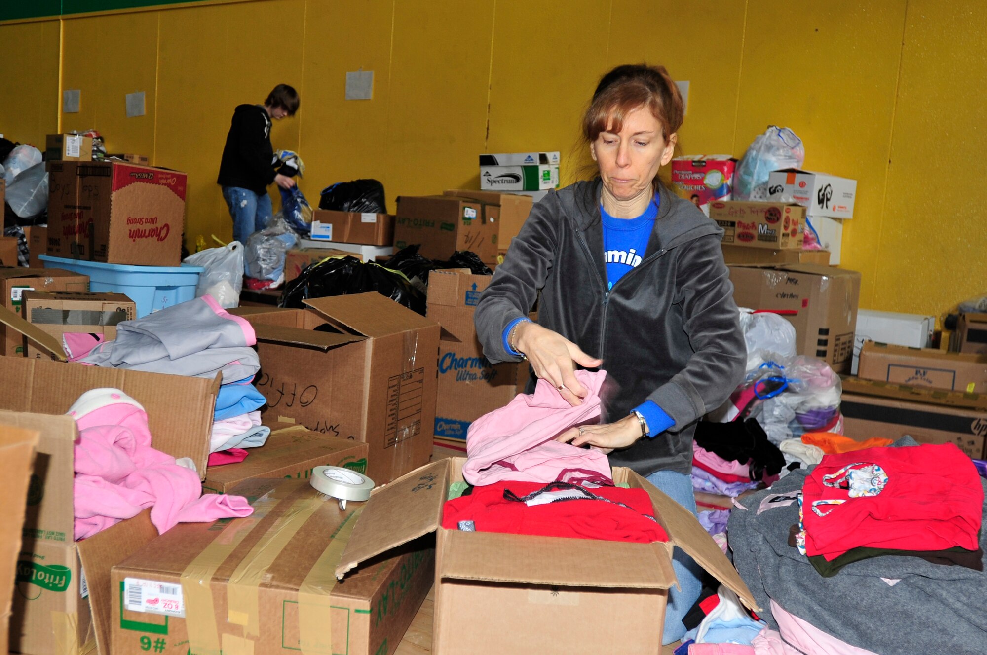 MISAWA AIR BASE, Japan -- Laurie Balmforth, boxes clothes at Edgren High School Mar. 15. Military members and their dependents volunteered their time to help sort through numerous donations that were taken for relief efforts during Operation Tomodachi. (U.S. Air Force photo by Staff Sgt. Marie Brown\Released)