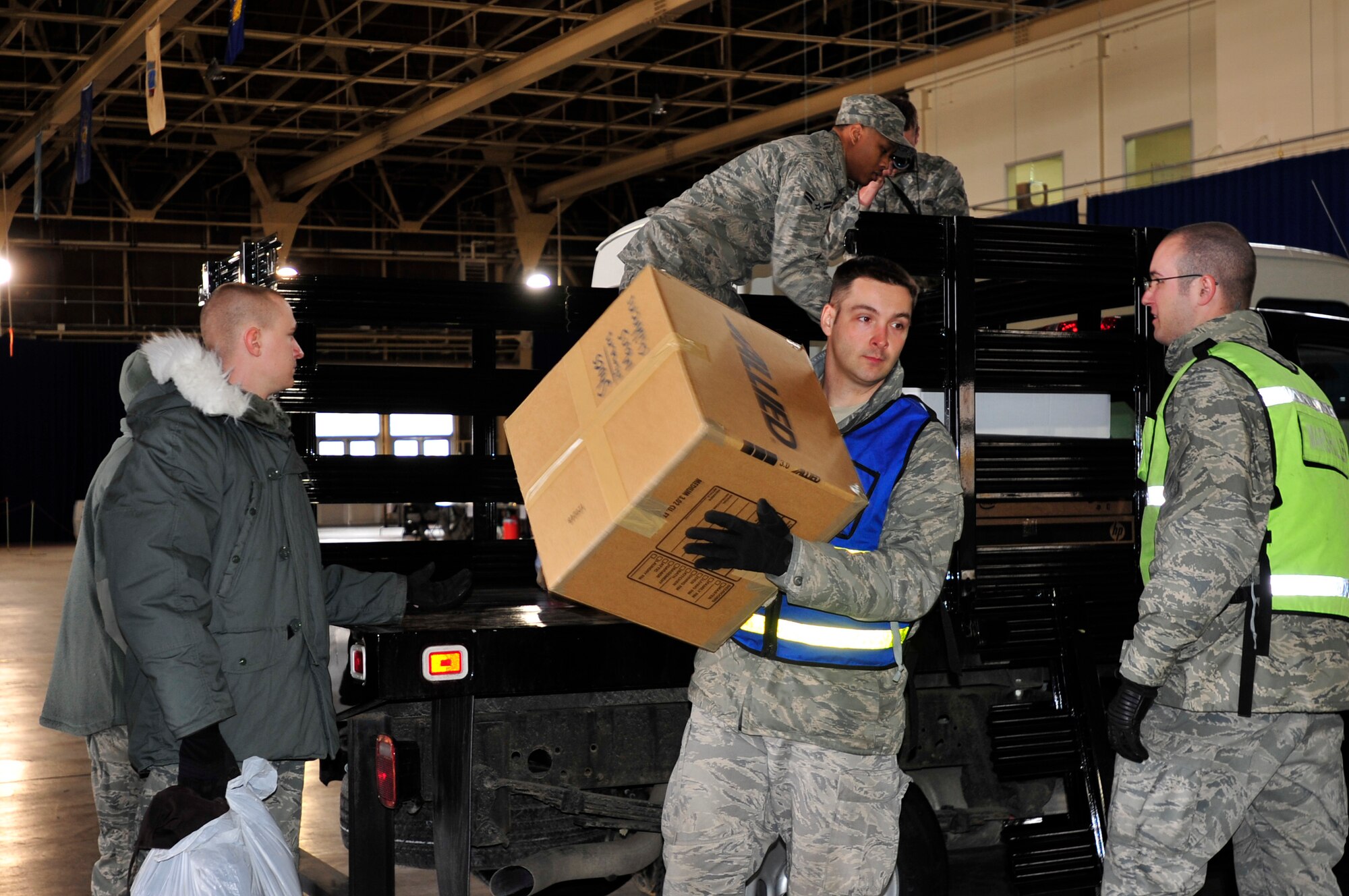 MISAWA AIR BASE, Japan -- Members of the 35th Logistics Readiness Squadron unload a truck filled with bags and boxes Mar. 15. Misawa Air Base residents came together to donate clothes, jackets, blankets and food for Japanese residents affected by last Friday's earthquake and tsunami. (U.S. Air Force photo by Staff Sgt. Marie Brown\Released)