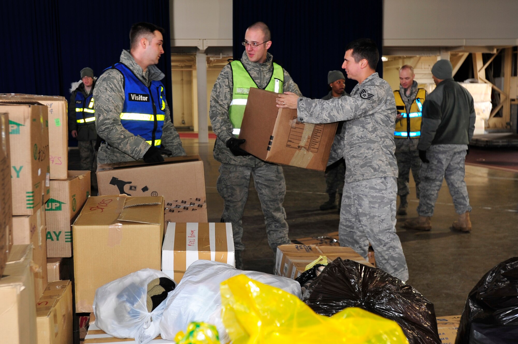 MISAWA AIR BASE, Japan -- Senior Airman Isaiah Bettinger and Bill McGuyer with Staff Sgt. James Anderson, 35th Logistics Readiness Squadron, stack boxes Mar. 15. Clothes, jackets, blankets and food were collected and taken to Sendai, Japan to help with relief efforts during Operation Tomodachi. (U.S. Air Force photo by Staff Sgt. Marie Brown\Released)