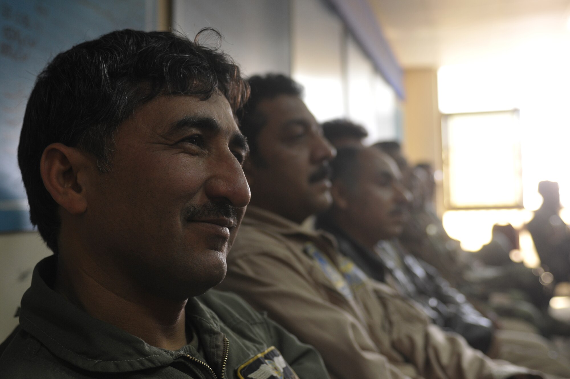KABUL, Afghanistan - Observers look on as Afghan Air Force Brig. Gen. Mohammed Barat, the Kabul Wing Commander, gives a speech at an aviaition English course graduation at the AAF Base in Kabul March 14. The course, split between varying levels of language proficiency ranging from elementary to intermediate, taught aviation-centric English meant to help the airmanship of Afghan pilots and was sponsored by the British Council, a U.K. based organization specializing in international education and cultural opportunities. (U.S. Navy photo by Mass Communications 2nd Class Vladimir Potapenko)
  
