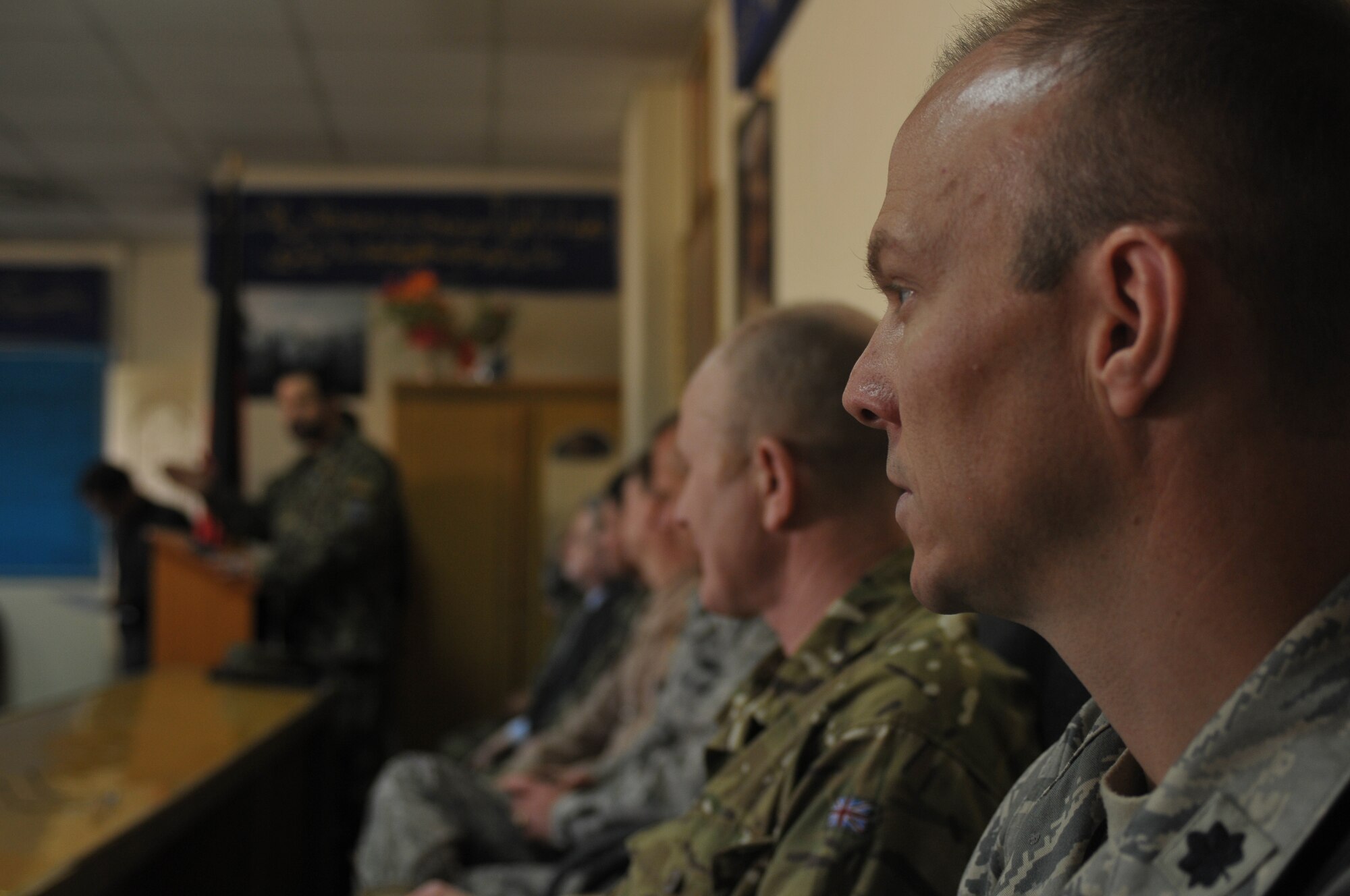 KABUL, Afghanistan - Observers look on as Afghan Air Force Brig. Gen. Mohammed Barat, the Kabul Wing Commander, gives a speech at an aviaition English course graduation at the AAF Base in Kabul March 14. The course, split between varying levels of language proficiency ranging from elementary to intermediate, taught aviation-centric English meant to help the airmanship of Afghan pilots and was sponsored by the British Council, a U.K. based organization specializing in international education and cultural opportunities. (U.S. Navy photo by Mass Communications 2nd Class Vladimir Potapenko)
  
