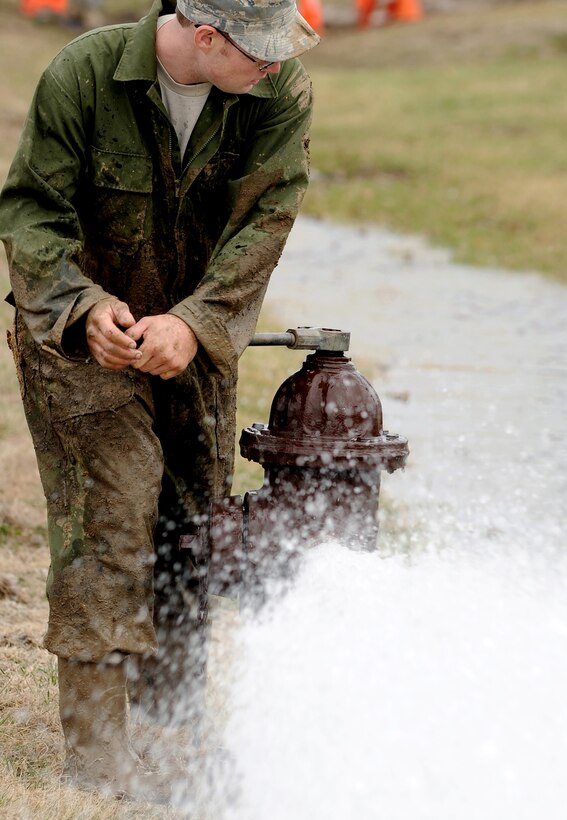 Air Force Staff Sgt. Justin England uses a fire hydrant to flush a repaired water main on Whiteman Air Force Base, Mo., March 7, 2011. England is a maintenance specialist assigned to the 509th Civil Engineer Squadron. 