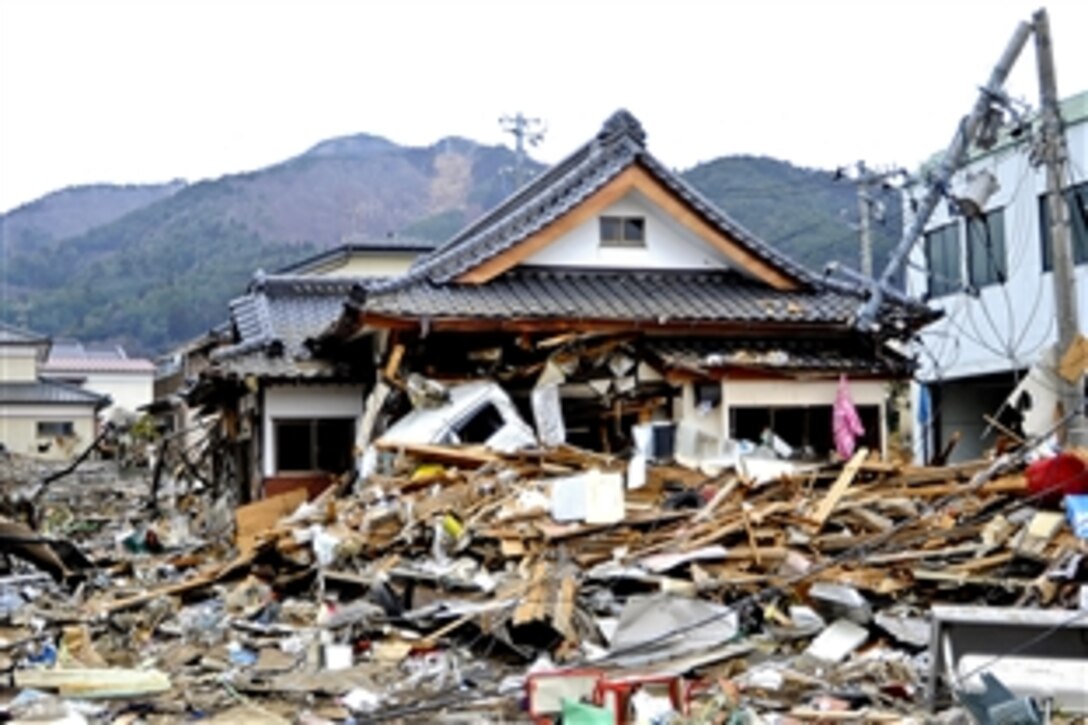 The remnants of a house lie amidst the rubble in Ofunato, Japan, March 15, 2011, following an 8.9-magnitude earthquake, which triggered a devastating tsunami. Teams from the United States, United Kingdom and China are on the scene to assist in the search for missing residents. 