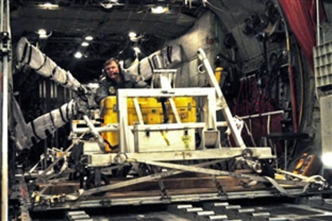 U.S. Navy Senior Chief Petty Officer Mike Wendelin moves supplies into position to be unloaded from a C-130 aircraft at Naval Air Facility Misawa, Japan, March 16, 2011. The cargo will support the relief efforts conducted by Patrol Squadron 4 following an 8.9-magnitude earthquake and tsunami. Wendelin is assigned to the Fleet Logistics Support Squadron 62, a reserve unit based in Jacksonville, Fla.