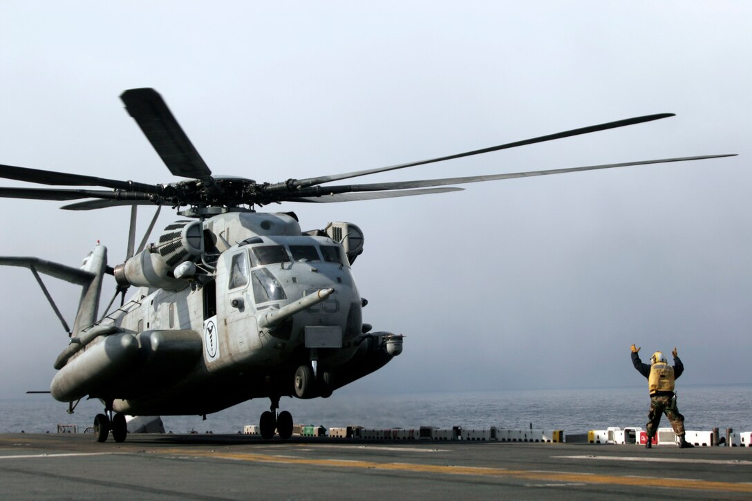 A Sailor signals the Marine pilots of a CH-53E Super Stallion with Marine Medium Helicopter Squadron 262 (Reinforced), 31st Marine Expeditionary Unit, as it takes off during flight operations March 17. The 31st MEU continues to transit to the coast of mainland Japan for potential humanitarian assistance in support of Operation Tomodachi.  Marines and sailors of the 31st MEU are making preparations for disaster relief efforts after an 8.9 earthquake and subsequent tsunami struck Japan causing widespread damage. The 31st MEU is ready to support our Japanese partners and to provide assistance when called upon.