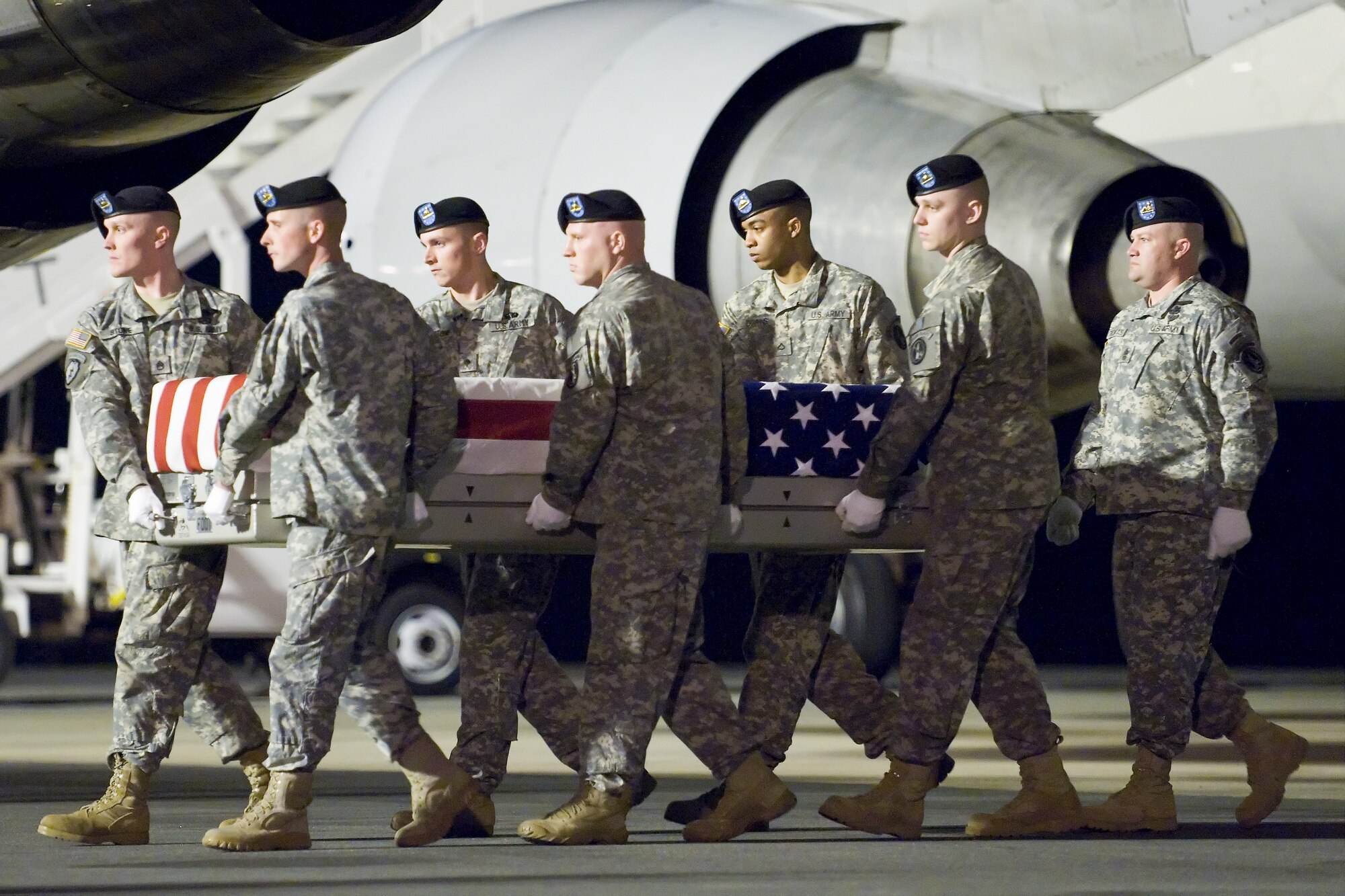 A U.S. Army carry team transfers the remains of Army Sgt. Travis M. Tompkins, of Lawton, Okla., at Dover Air Force Base, Del., March 17, 2011. Tompkins was assigned to the Brigade Special Troops Battalion, 4th Brigade Combat Team, 10th Mountain Division, Fort Polk, La. (U.S. Air Force photo/Roland Balik)