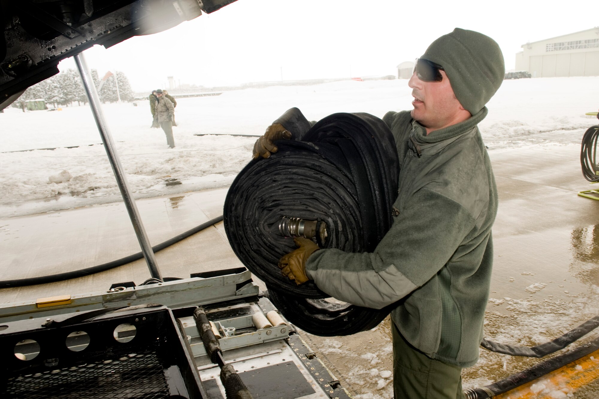 Tech. Sgt. Paul Hammer, 353rd Special Operations Group forward area refueling point (FARP) member, returns a fuel line to MC-130P Combat Shadow after defueling March 17. The FARP members defueled the MC-130P and fueled four fuel bladders worth 36,000 pounds of JP-8 fuel. FARPs allow aircraft to operate at distances further from the original airport that it departed from by allowing the aircraft to stop and refuel where typically no fuel is at. The FARP team is capable of providing fuel to remote and austere locations. The fuel at Yamagata Airport will be used for American forces search and recovery teams during Japan’s earthquake and tsunami relief. (U.S. Air Force photo/ Staff Sgt. Jonathan Steffen)