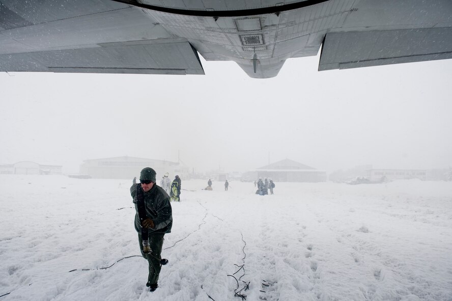 Tech. Sgt. Paul Hammer, 353rd Special Operations Group forward area refueling point (FARP) member, runs a fuel line to an MC-130P Combat Shadow March 17. The FARP members defueled the MC-130P and fueled four fuel bladders for a total of 36,000 pounds of JP-8 fuel. FARPs allow aircraft to operate at further distances by allowing the aircraft to stop and refuel where typically no fuel exists. The FARP team is capable of providing fuel to remote and austere locations. The fuels at Yamagata Airport will be used for American forces search and recovery teams during Japan’s earthquake and tsunami relief. (U.S. Air Force photo/ Staff Sgt. Jonathan Steffen) 