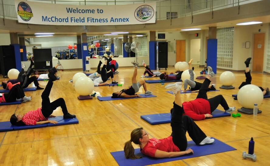 Airmen and spouses perform callisthenic exercises during the McChord Field Fitness Annex's cardio tone class March 9, 2011, at Joint Base Lewis-McChord, Wash. The various weekly classes and services offered at the McChord Field Fitness Annex give service members and families an opportunity to honor National Nutrition Month by meeting routine exercise needs while maintaining a healthy diet. (U.S. Air Force Photo/Airman 1st Class Leah Young) 