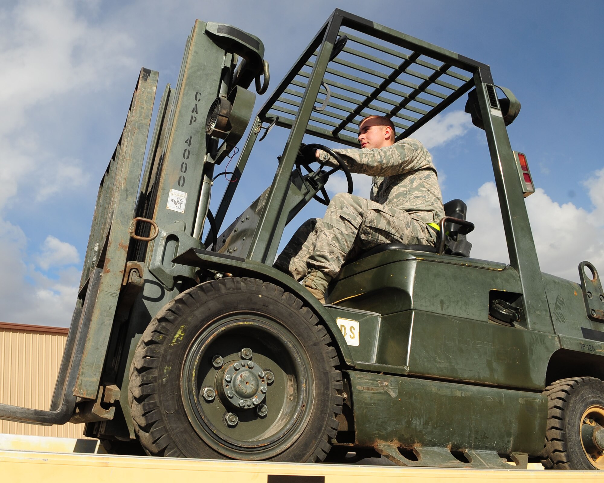 DAVIS-MONTHAN AIR FORCE BASE, Ariz. -An Airman from the 355th Equipment Maintenance Squadron uses a forklift to load and unload munitions at the weapons storage area here Jan. 31. (U.S. Air Force photo/Airman 1st Class Jerilyn Quintanilla)