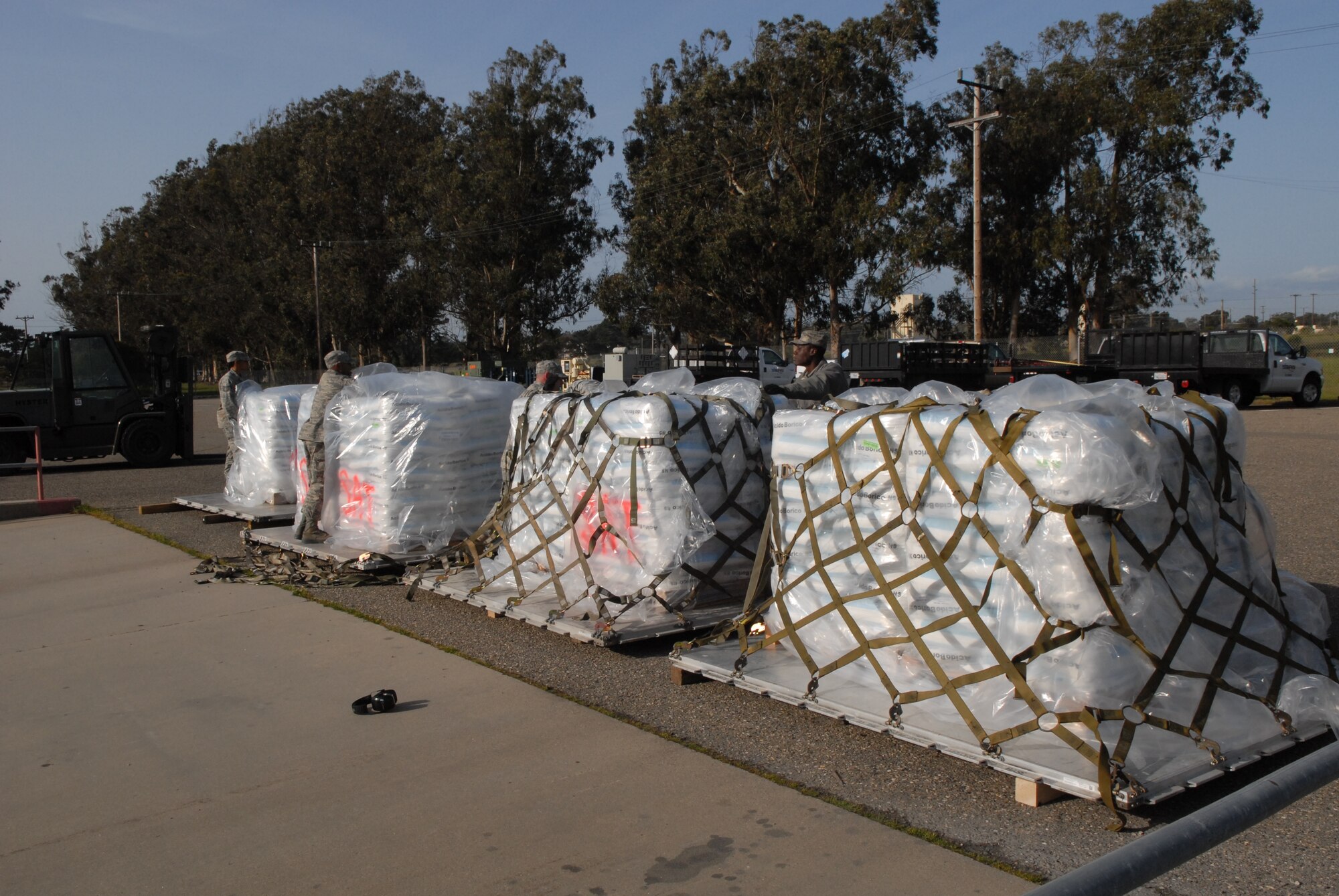 VANDENBERG AIR FORCE BASE, Calif. - Members of the 30th Logistics Readiness Squadron Transportation Management Office, prepare pallets of boric acid for shipment to Japan on Wednesday, March 16, 2011. Approximately 34,000 pounds of boric acid from the Diablo Canyon Power Plant is being sent to aid in the cooling of Japan's Fukushima Daiichi Nuclear Complex. Boric acid is used in nuclear power plants to control the fission rate of uranium. (U.S. Air Force photo/ Jerry E. Clemens, Jr.)