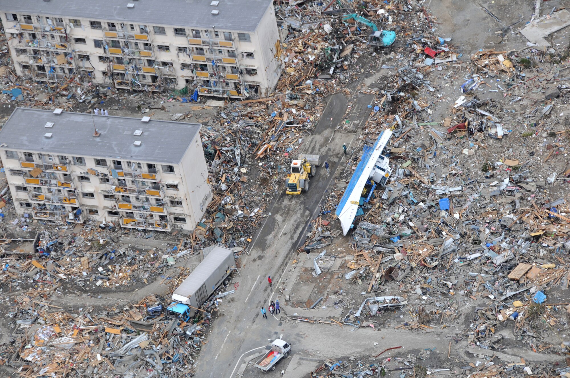 An Air Force search and rescue team in an HH-60 G Pave Hawk helicopter surveys the damage as it flies over Sendai, Japan, March 14, 2011. (U.S. Air Force photo/Airman 1st Class Katrina R. Menchaca)
