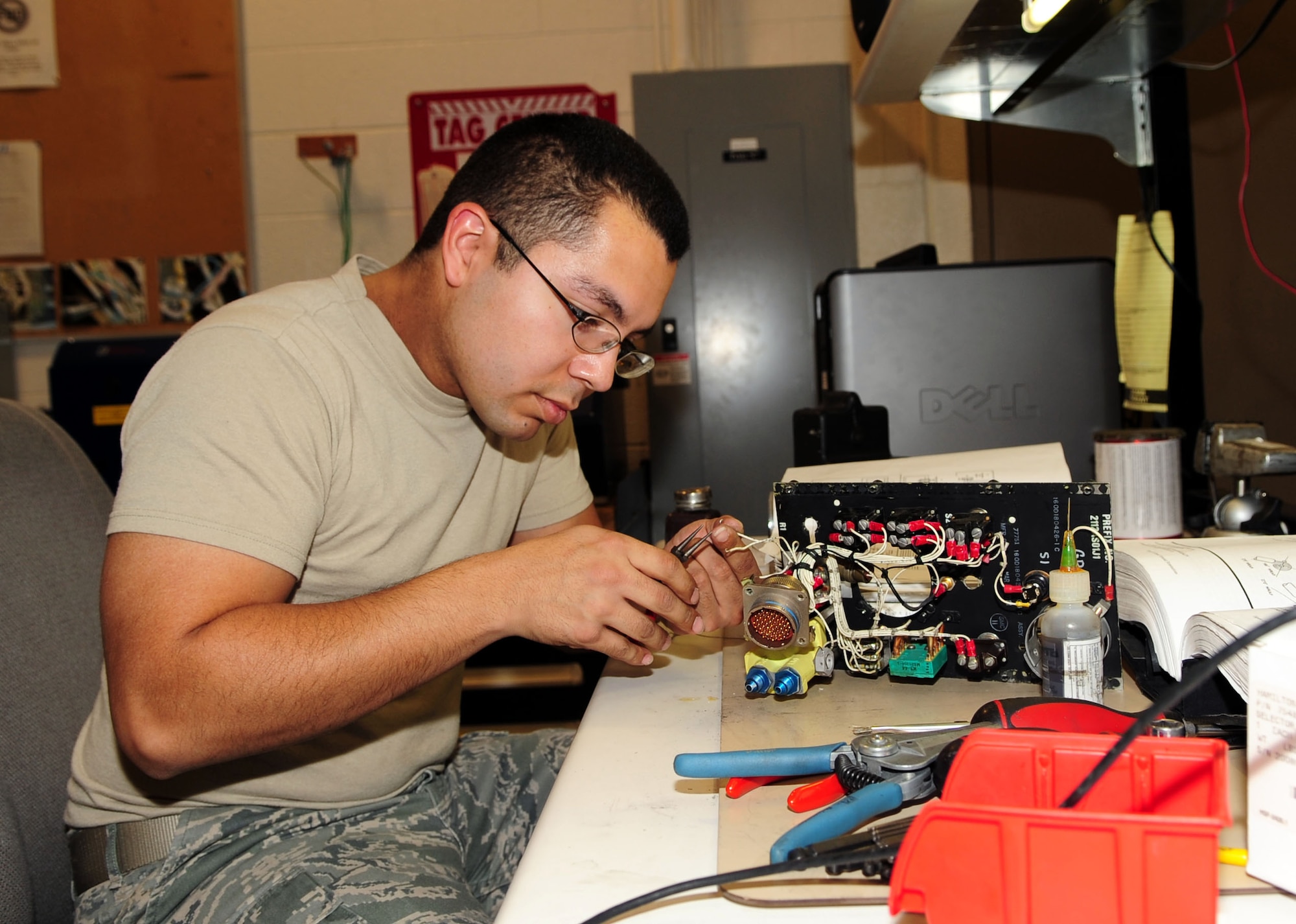 DAVIS-MONTHAN AIR FORCE BASE, Ariz. - Airman 1st Class Vincent Cruz, from the 355th Component Maintenance Squadron, prepares to solder wires of an emergency flight control panel here Jan. 31. (U.S. Air Force photo/Airman 1st Class Jerilyn Quintanilla)