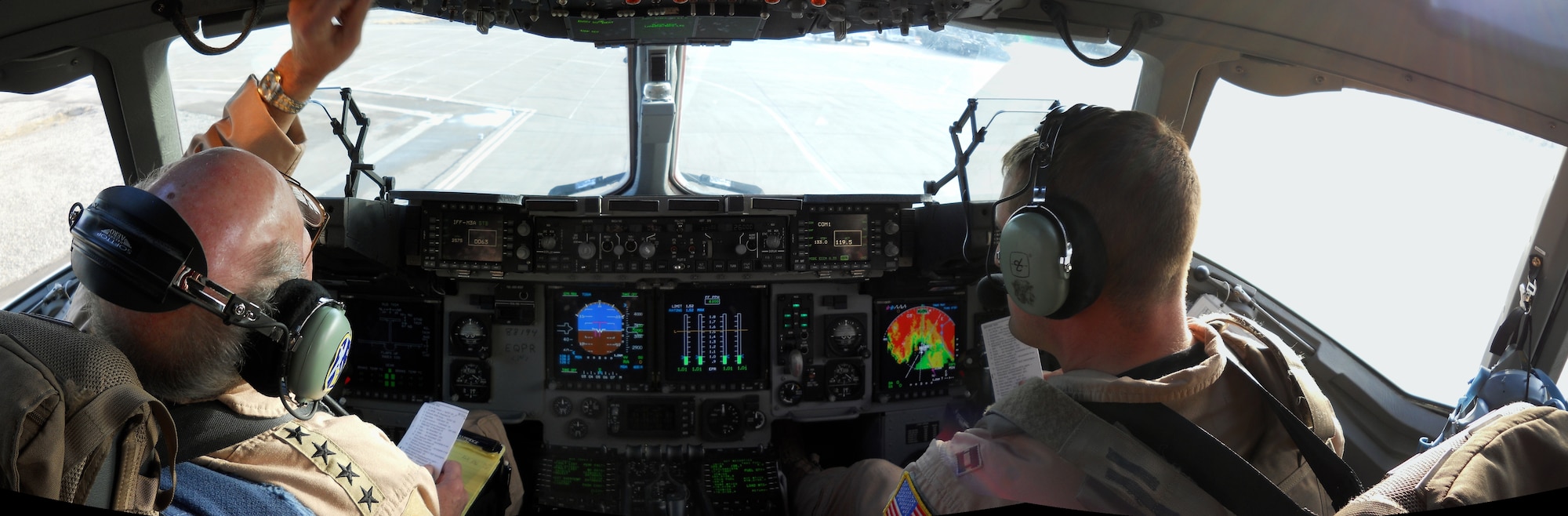 Gen. Duncan McNabb, left, U.S. Transportation Command commander, works with Capt. Andrew Oiland, a C-17 pilot deployed from the 7th Airlift Squadron at McChord Field, to prepare for their flight over Afghanistan. General McNabb has a senior staff qualification in the C-17, and flew with the 816th Expeditionary Airlift Squadron during a recent overseas trip. The 7th AS deployed in December to take over the responsibilities of the 816th EAS and will return late this spring. (Courtesy photo illustration/Maj. Trace Dotson)