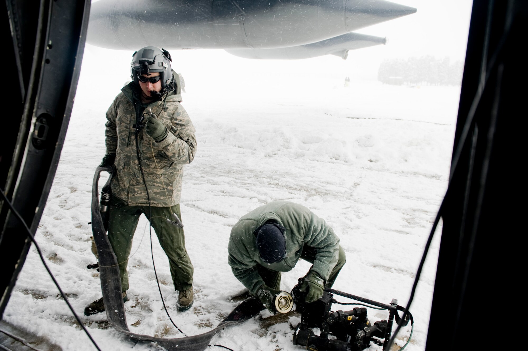 YAMAGATA, Japan--Staff Sgt. Nicholas Wisnoski, 17th Special Operations Squadron loadmaster, and Tech. Sgt. Timothy Rodgers, 353rd Special Operations Group forward area refueling point (FARP) member, setup equipment to defuel an MC-130P Combat Shadow March 17. The FARP members defueled the MC-130P and fueled four fuel bladders for a total of 36,000 pounds of JP-8 fuel. FARPs allow aircraft to operate at further distances by allowing the aircraft to stop and refuel where typically no fuel exists.  The FARP team is capable of providing fuel to remote and austere locations. The fuels at Yamagata Airport will be used for American forces search and recovery teams during Japans earthquake and tsunami relief. (U.S. Air Force photo/ Staff Sgt. Jonathan Steffen)

