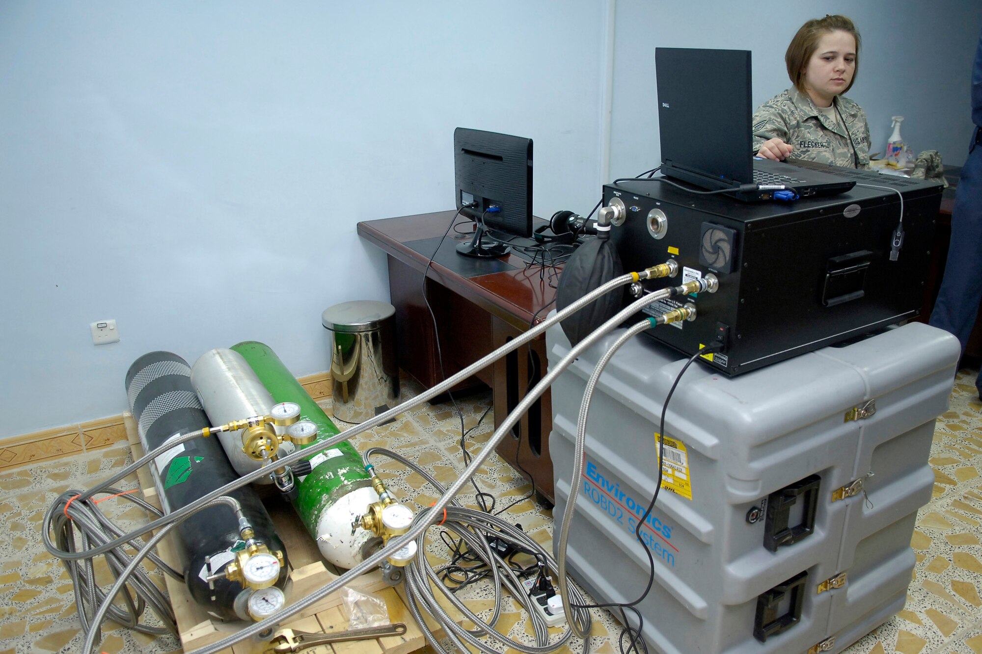 Tech. Sgt. Jennifer Flecker prepares Iraq's first reduced oxygen breathing device for a demonstration March 14, 2011, in Bagdhad. Sergeant Flecker is an aerospace operational physiology technician deployed to teach Iraqi airmen to use the device, which is designed to take the place of the altitude chamber for pilot refresher training. (U.S. Air Force photo/Tech. Sgt. Randy Redman)