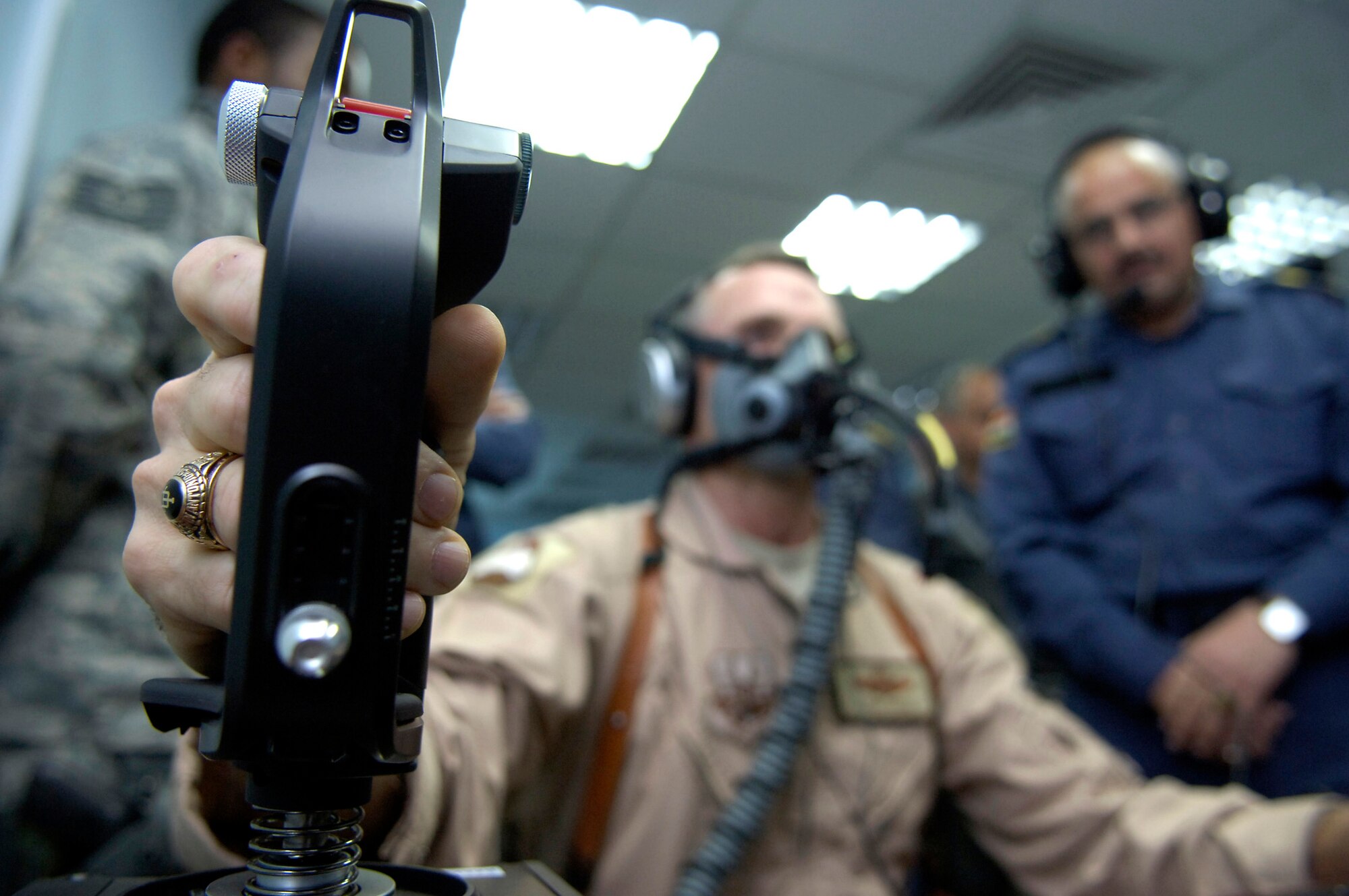 Brig. Gen. Anthony Rock makes minor flight corrections using the control stick during a demonstration of the Iraqi air force's first reduced oxygen breathing device March 14, 2011,in Baghdad. The ROBD2 is the second generation of a device invented and patented by the Navy designed to take the place of the altitude chamber for pilot refresher training. General Rock is the 321st Air Expeditionary Wing commander and Iraq Training and Advisory Mission-Air director. (U.S. Air Force photo/Tech. Sgt. Randy Redman)