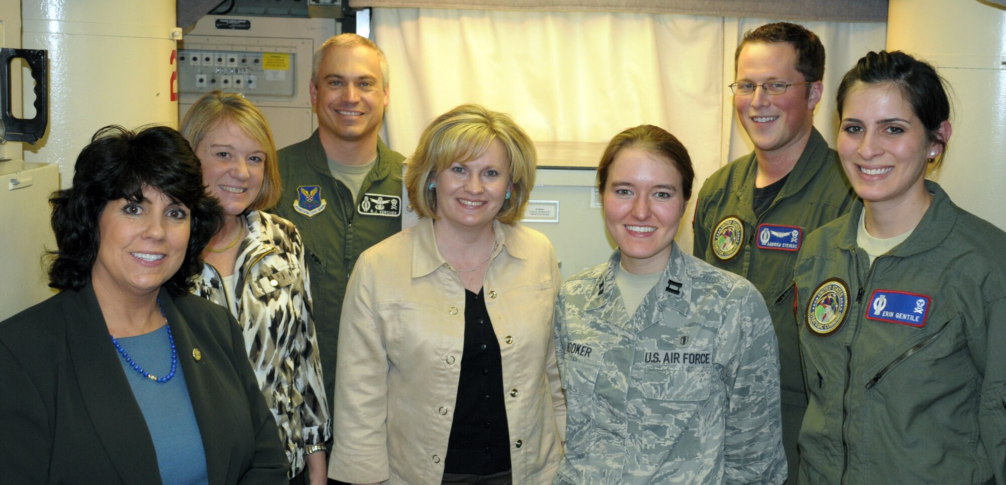 Ana Alston, Julie Kowalski and Julie Tims stand alongside Col. Robert Vercher, 90th Operations Group commander inside a launch control center near Burns, Neb. earlier this week. Also photographed are Capt. Sarah Hooker, 90th Medical Support Squadron, 1st Lt. Andrew Stevens and 2nd Lt. Erin Gentile from the 319th Missile Squadron. (U.S. Air Force by Blaze Lipowski)