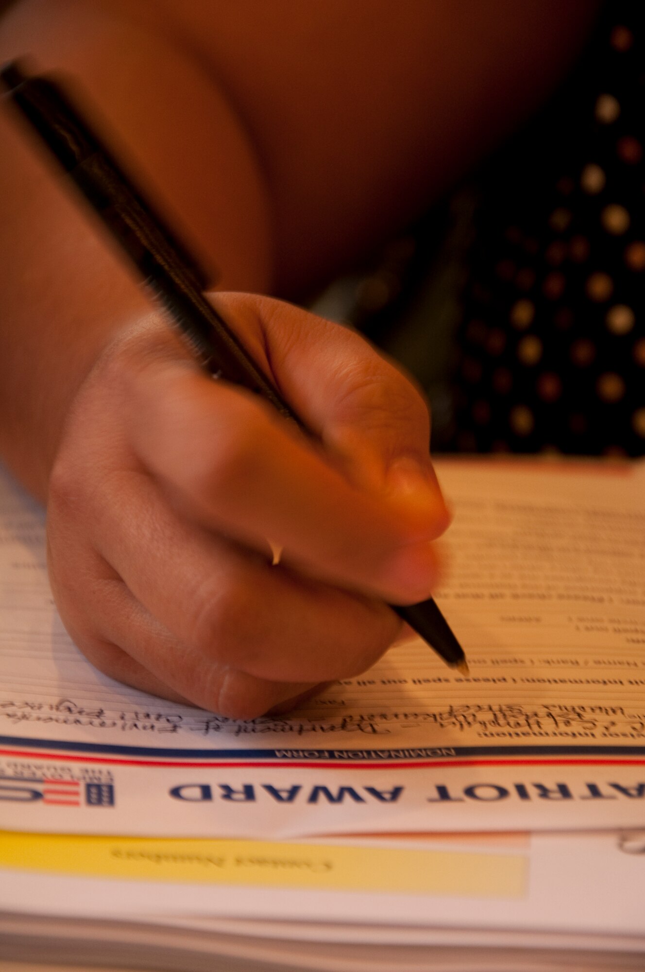 Ponciana Quindica fills out a Patriot Award Form. The Patriot Award is designed to recognize civilian bosses for their support of Guard and Reserve members. It is awarded to those who go above and beyond to support Guardsmen, Reservists and their families during deployments and in day-to-day duties. U.S. Air Force Photo/Staff Sgt. Erin Smith
