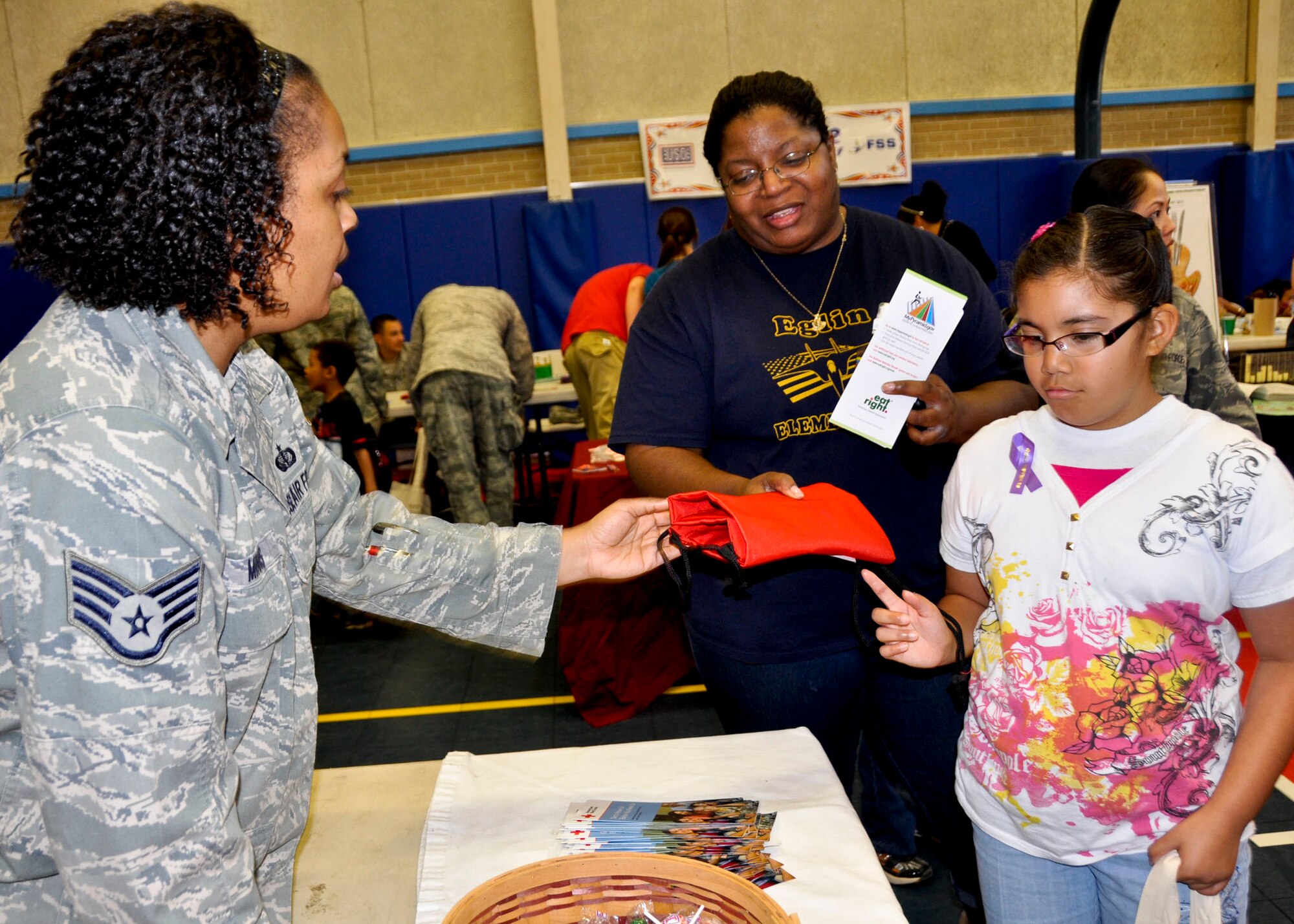 A child chooses a Red Cross bag at the “Because We Care” program at the Eglin Youth Center gym March 16.  The event featured activities and information for children who have or will have a military parent deployed in 2011.  (U.S. Air Force photo/Kevin Gaddie)