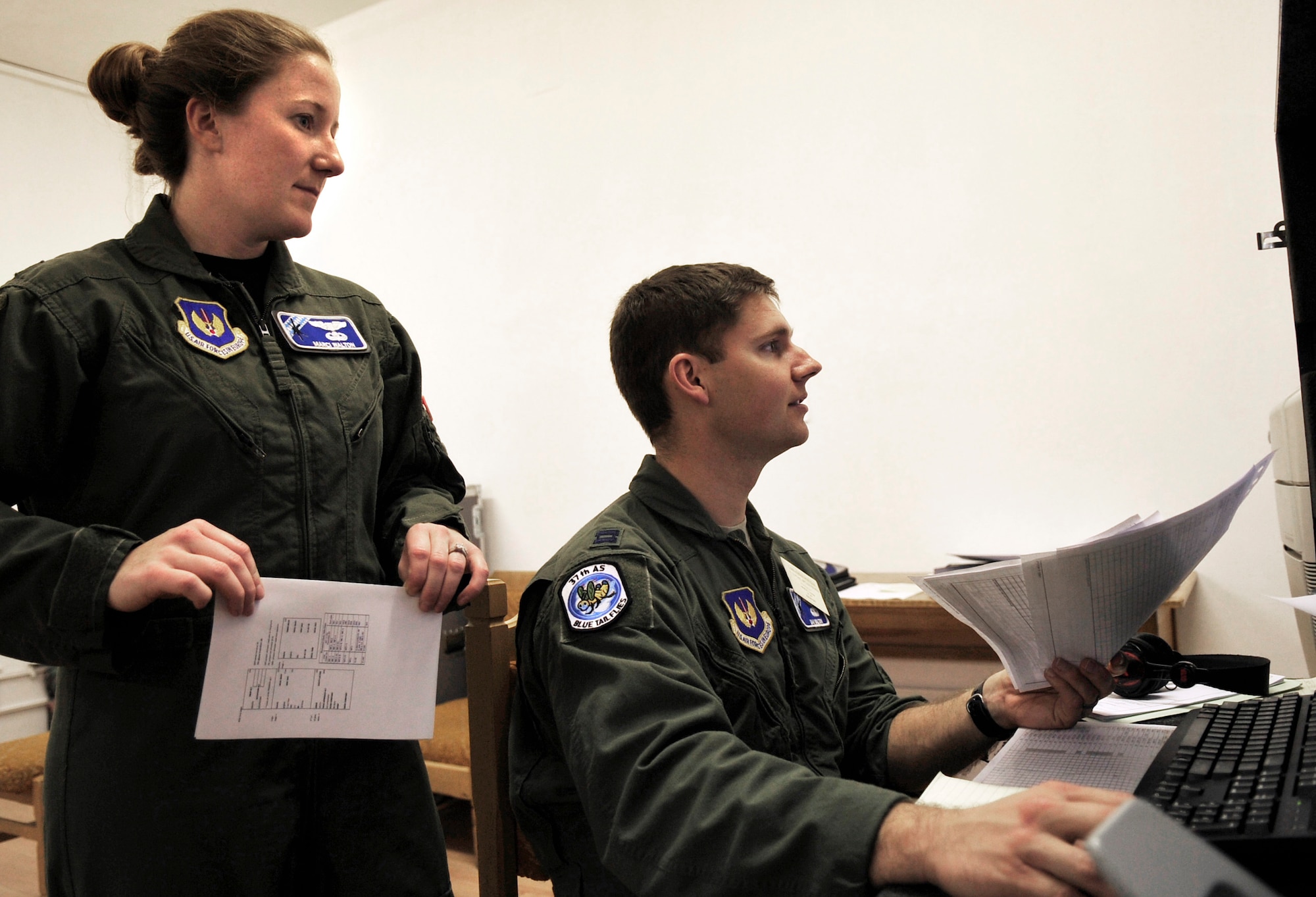 U.S. Air Force Captains Marci and Dan Walton, 37th Airlift Squadron pilots, work side-by-side in the command center of Carpathian Spring 2011, Airlift Base Otopeni, Romania March 17, 2011. Capt. Marcie Walton is serving as chief of tactics and Capt. Dan Walton as mission commander of this exercise. This is the first time the married couple has had the opportunity to work together on this scale. Carpathian Spring 2011is a building partnership capacity exercise where members of the U.S. military join their Romanian counterparts to learn from one another and strengthen alliances. (U.S. Air Force Photo by Tech Sgt. Jocelyn L. Rich)