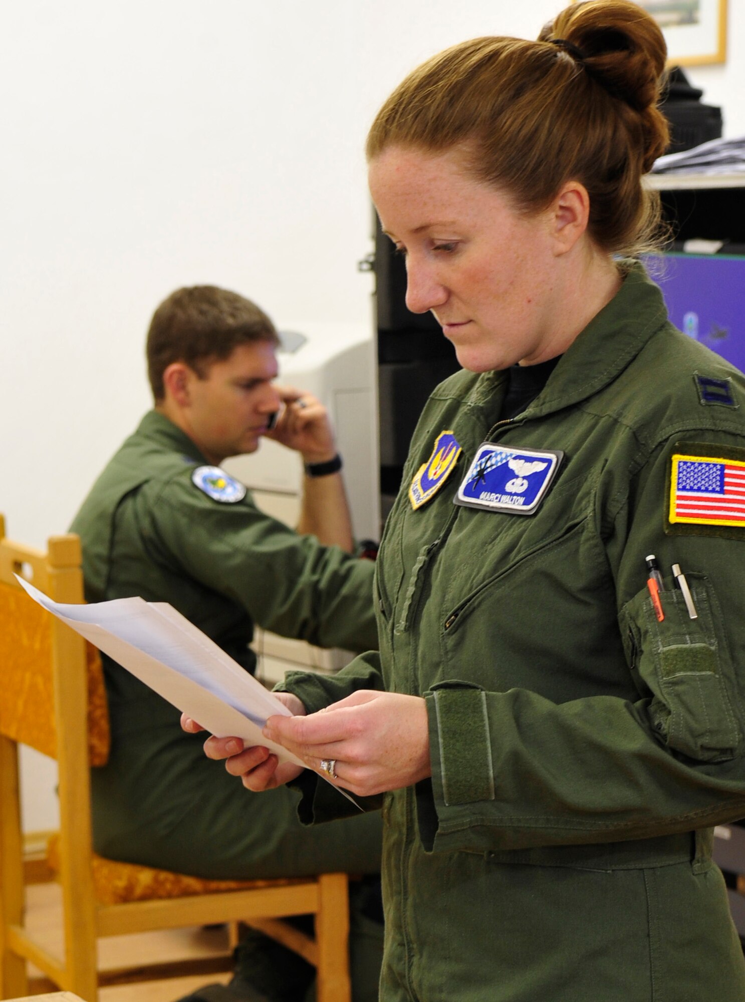 U.S. Air Force Captains Marci and Dan Walton, 37th Airlift Squadron pilots, work side-by-side in the command center of Carpathian Spring 2011, Airlift Base Otopeni, Romania March 17, 2011. Capt. Marcie Walton is serving as chief of tactics and Capt. Dan Walton as mission commander of this exercise. This is the first time the married couple has had the opportunity to work together this closely. Carpathian Spring 2011 is a building partnership capacity exercise where members of the U.S. military join their Romanian counterparts to learn from one another and strengthen alliances. (U.S. Air Force Photo by Tech Sgt. Jocelyn L. Rich)