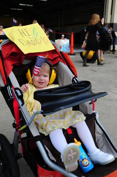 SEYMOUR JOHNSON AIR FORCE BASE, N.C. – Gwendolyn LaFountain, daughter of Capt. Andrew LaFountain, waves the American flag while waiting for her father’s F-15E Strike Eagle to taxi by March 16, 2011. This was the second deployment the LaFountain family has experienced. Captain LaFountain is a 336th Fighter Squadron weapon systems officer, who hails from Denver. (U.S. Air Force photo/Senior Airman Rae Perry) (RELEASED)