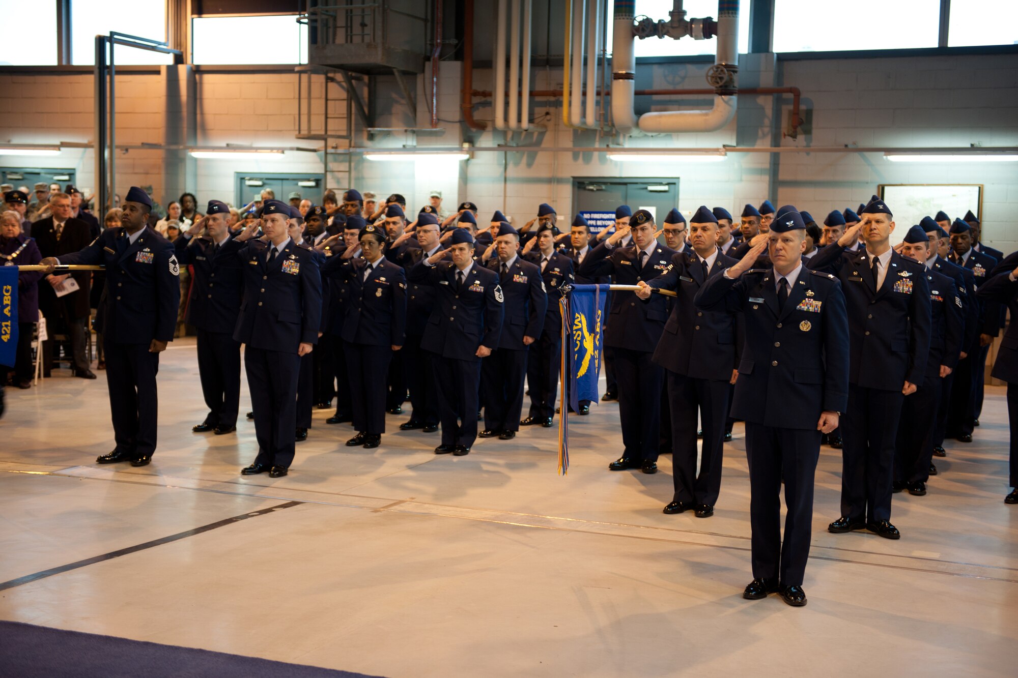 RAF ALCONBURY, United Kingdom - Airmen of the 501st Combat Support Wing render the wing’s first salute to their new commander, Col. Brian Kelly, during a change of command ceremony March 17 at RAF Alconbury. (U.S. Air Force photo by Tech. Sgt. John Barton)