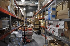 This before photo shows inventory that lined the aisles between stock shelves in the warehouse at the Charles C. Carson Center for Mortuary Affairs. As part of an Air Force Smart Operations for the 21st Century initiative, a team conducted a 6S project on the warehouse where the focus was safety, sort, straighten, shine, standardize and sustain. (U.S. Air Force photo/Christin Michaud)