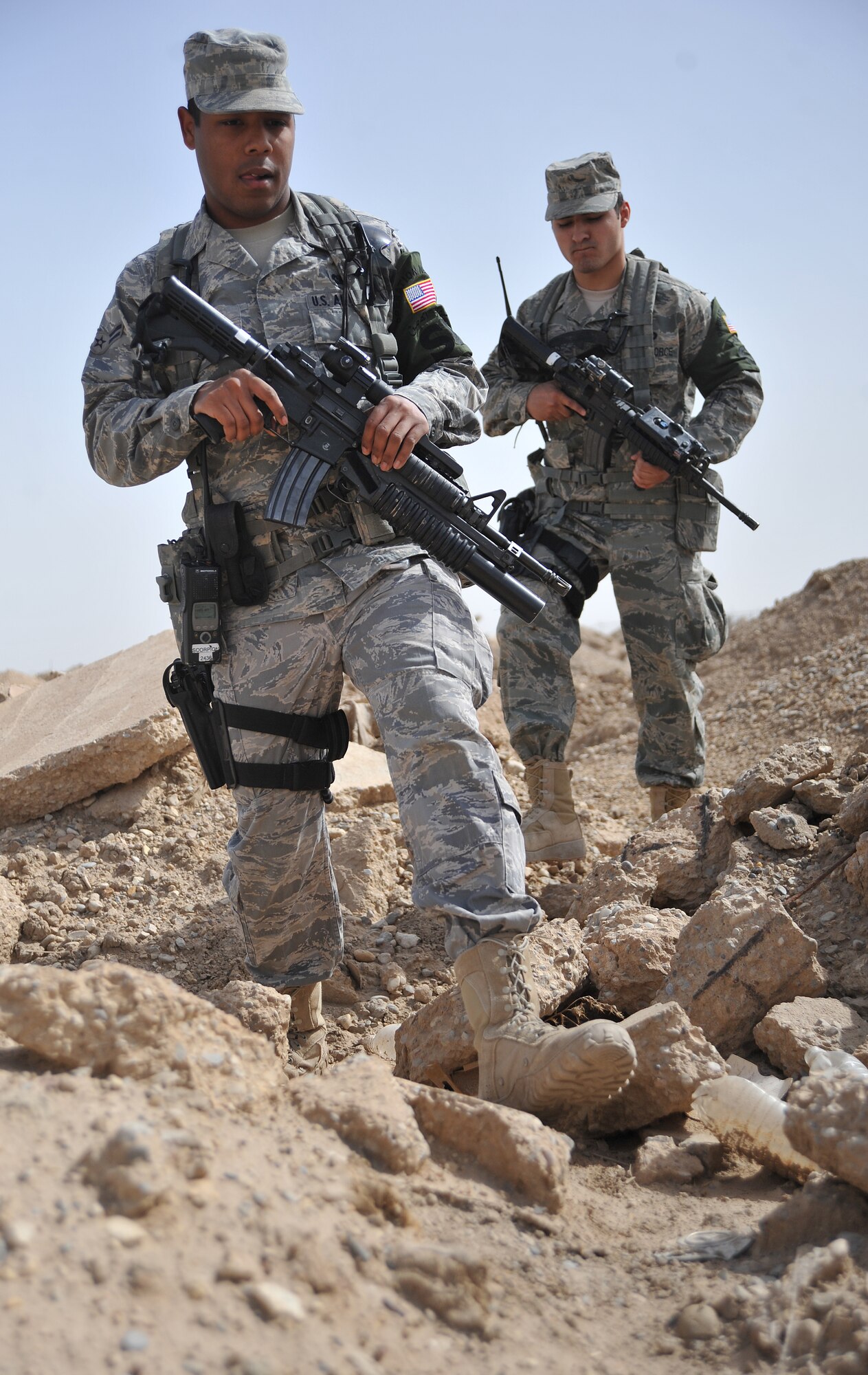 Airman 1st Class Eric Colon, 407th Expeditionary Security Forces Flight patrolman and Akron, Ohio, native, and Senior Airman Adrian Cavazos, 407th ESFF patrolman and Fresno, Calif., native, conduct foot patrols Feb. 21, 2011, on the 1,400 acre airfield at Ali Air Base, Iraq. (U.S. photo by Senior Airman Andrew Lee/Released)