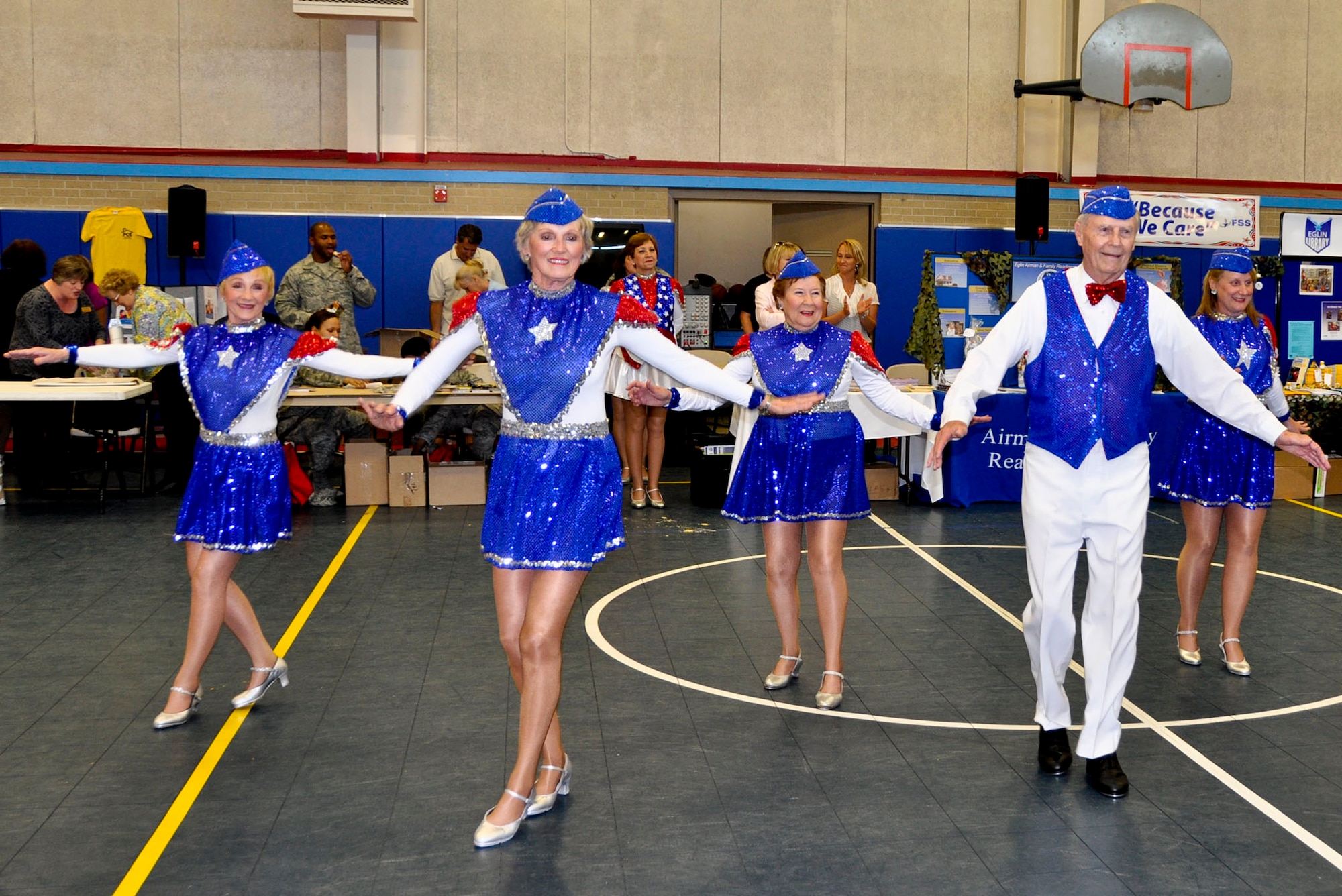 “The High Steppers,” a local group of patriotic community members, perform show dance and tap numbers for the audience at the “Because We Care” program at the Eglin Youth Center gym March 16.  The event featured activities and information for children who have or will have a military parent deployed in 2011.  (U.S. Air Force photo/Kevin Gaddie)