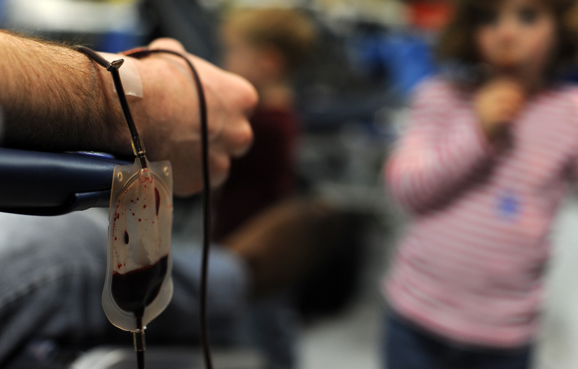 WHITEMAN AIR FORCE BASE, Mo. -- Blood streams from a donors arm during an Armed Services Blood Program blood drive March 16, 2011. The blood collected will be used to care for deployed forces. (U.S. Air Force photo by Senior Airman Kenny Holston)(Released)

