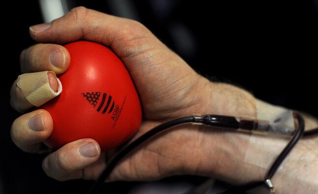 WHITEMAN AIR FORCE BASE, Mo. -- Capt. Kevin Normile, 509th Bomb Wing judge advocate chief of labor and contract law, squeezes an Armed Services Blood Program squishy-ball to get his blood pumping during an ASBP blood drive March 16, 2011.  The blood collected will be used to care for deployed forces. (U.S. Air Force photo by Senior Airman Kenny Holston)(Released)

