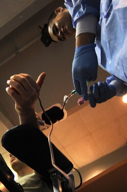 WHITEMAN AIR FORCE BASE, Mo. -- U.S. Army Sgt. Thomas Morgan, Medical Activity, laboratory Sgt. (right) draws blood from 2nd Lt. Eric Birdsong, 509th Logistics Readiness Squadron, March 16, 2011. Members of the Armed Services Blood Program drew blood from several donors and ensured everything went smoothly. The blood collected will be used to care for deployed forces. (U.S. Air Force photo by Senior Airman Kenny Holston)(Released)


