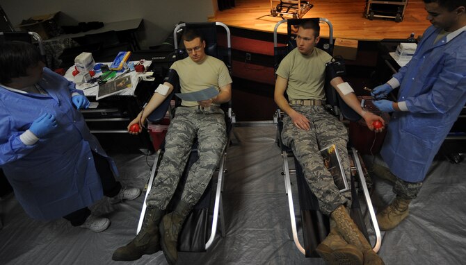 WHITEMAN AIR FORCE BASE, Mo. -- Capt. Kevin Normile, 509th Bomb Wing judge advocate, chief of labor and contract law, (left) and 2nd Lt. Eric Birdsong, 509th Logistics Readiness Squadron, donate blood during an Armed Services Blood Program blood drive March 16, 2011.  The blood collected will be used to care for deployed forces. (U.S. Air Force photo by Senior Airman Kenny Holston)(Released)

