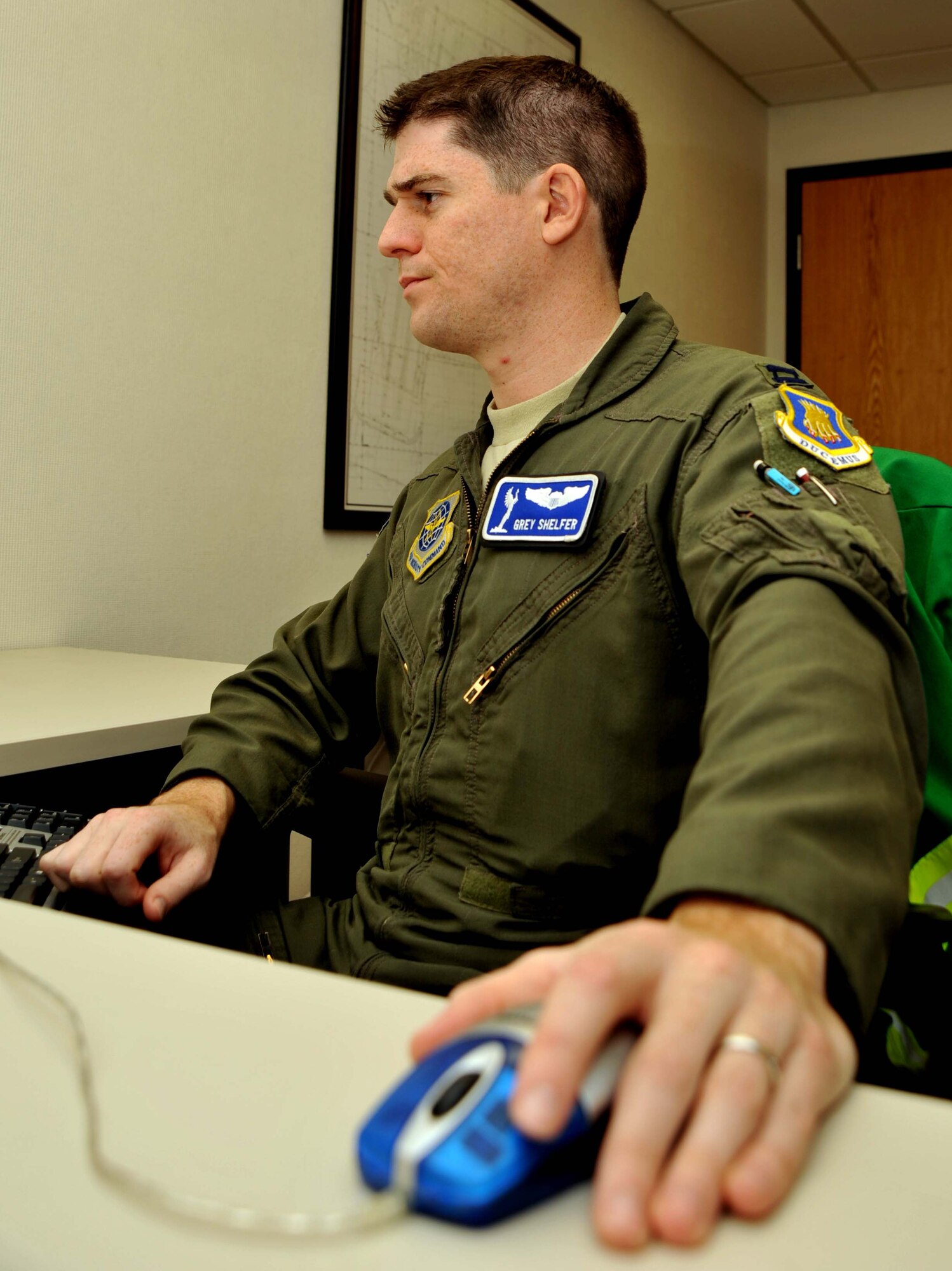 Capt. Grey Shelfer, 22nd Air Refueling Wing Flight Safety officer and KC-135 Stratotanker Instructor pilot, scours through his e-mail at the safety office, after completing a flying mission hours earlier.  As the 22nd ARW Flight Safety officer, the Lehigh Acres, Fla., native is responsible for mishap investigations and ensuring safe flight operations.  (U.S. Air Force photo/Senior Airman Abigail Klein)