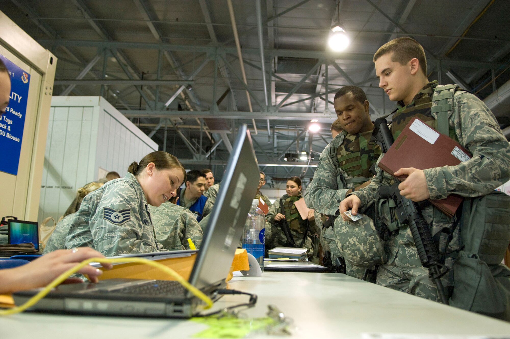HANSCOM AIR FORCE BASE, Mass. - Staff Sgt. Meghan Reiter (left) of the 66th Medical Squadron gathers information from Senior Airman Phillip Prather and Airman Samuel Mataraza, both from the 66th Security Forces Squadron, during a deployment exercise scenario March 14. A number of Base Readiness Exercise scenarios were conducted throughout the week to test deployment and emergency response readiness in preparation for an Operational Readiness Inspection. (U.S. Air Force photo by Mark Wyatt)