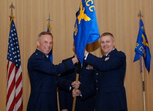 Brig. Gen. Steven J. Spano, Air Combat Command Director of Communications and Chief Information Officer, passes the squadron guidon to Lt. Col. Jeffery Brooks, ACC Communications Support Squadron commander, during an assumption of command ceremony March 1 at Quesada Hall at Langley Air Force Base, Va. ACC redesignated the ACC Communications Group as the ACC CSS and inactivated the 82d CSS. (U.S. Air Force photo by Senior Master Sgt. Elaine A. Lewis/RELEASED)