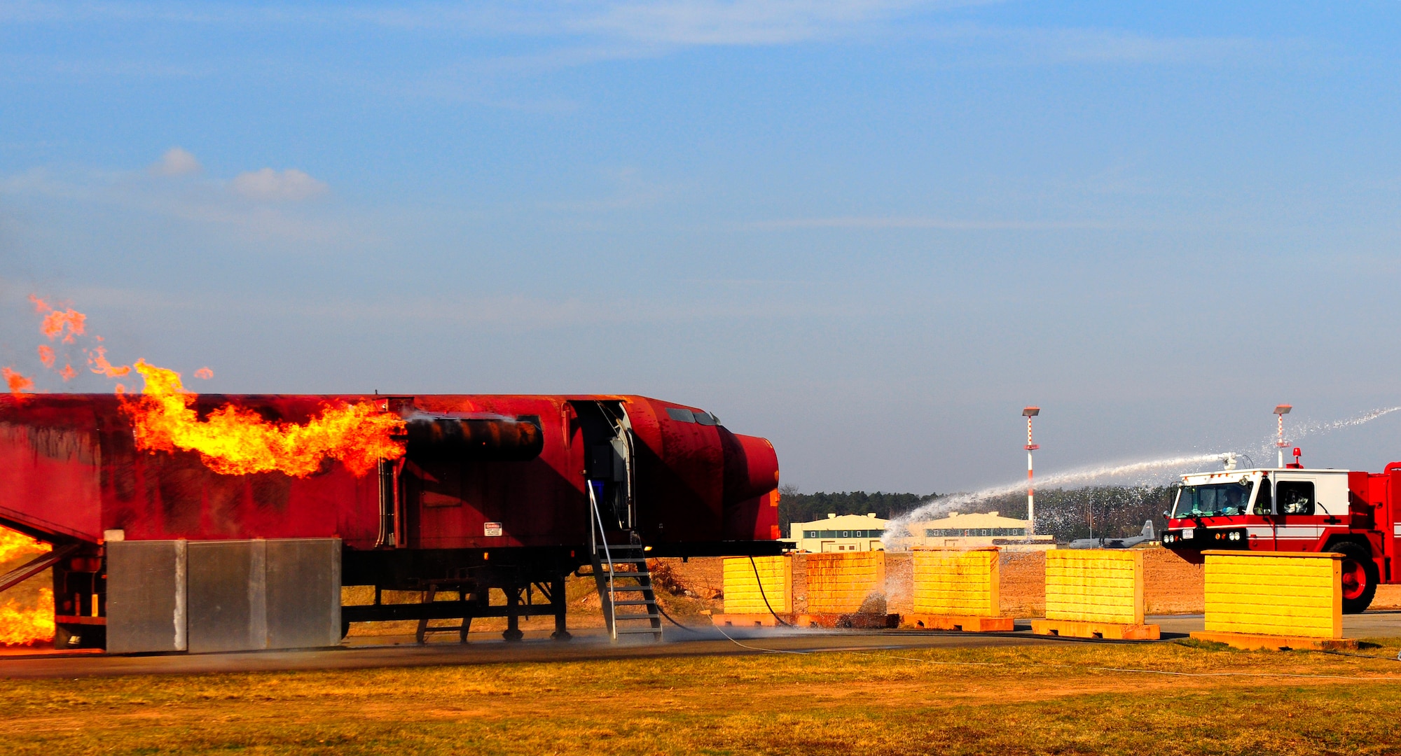 U.S. Air Force firefighters douse a simulated engine fire during the Silver Flag exercise, Ramstein Air Base, Germany, March 15, 2011. Silver Flag is a weeklong  training program that Airmen from all over the world participate in. Silver Flag combines classroom and practical application exercises to prepare airmen for deployment. (U.S. Air Force Photo by Airman 1st Class Brea Miller)