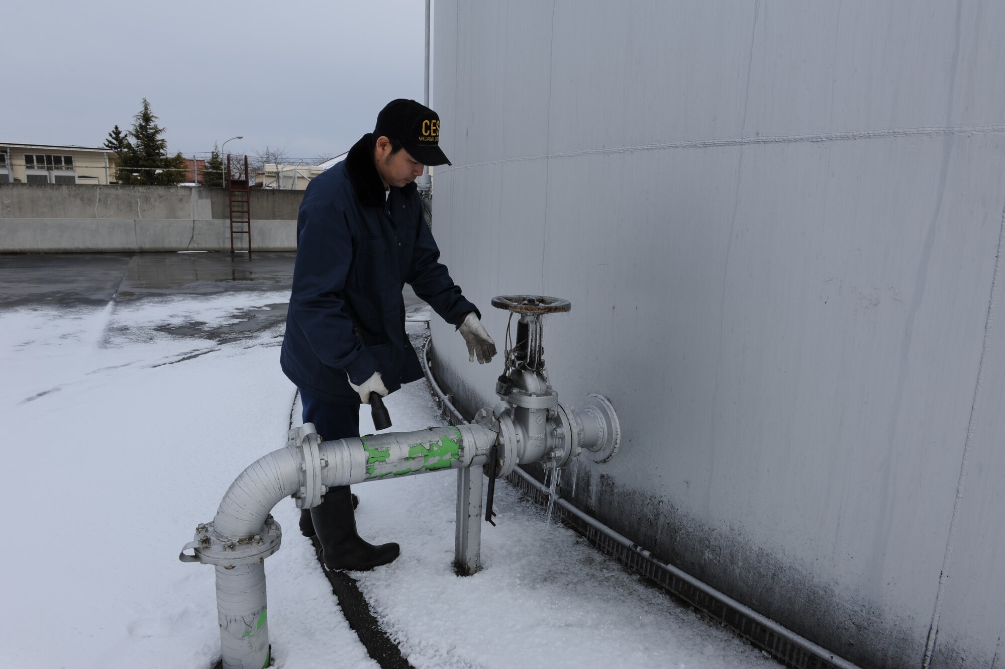 MISAWA AIR BASE, Japan –Ogasawara Hideyuki, 35th Civil Engineer Squadron, inspects valves and pipes of fuel tanks for the base’s boiler system Mar. 17. The fuel tanks are inspected three times a day. (U.S. Air Force Tech. Sgt. Russell J. McBride\Released)