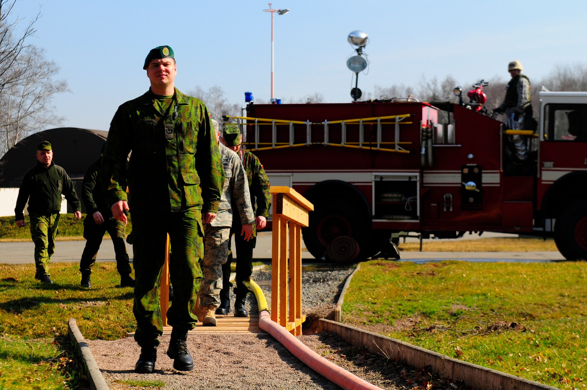 Lithuanian Air Force officers approach a simulated fire drill during Silver Flag, Ramstein Air Base, Germany, March 15, 2011. Silver Flag is a weeklong training program that invites Airmen from all over the world to participate in. Silver Flag combines classroom and practical application exercises to prepare airmen for deployment. (U.S. Air Force Photo by Airman 1st Class Brea Miller)