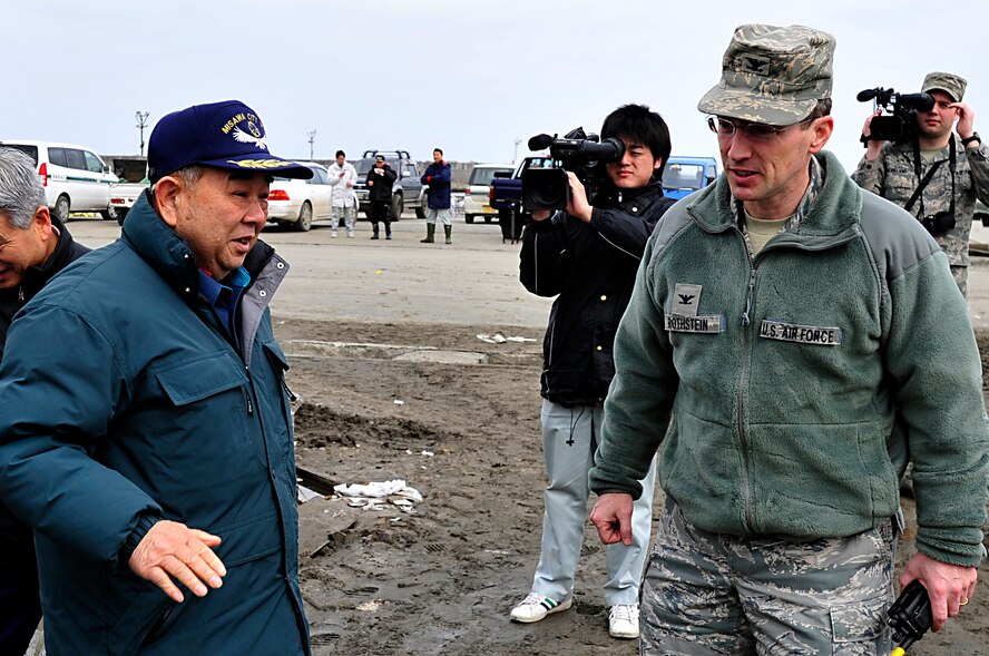 MISAWA AIR BASE, Japan -- Col. Michael Rothstein, 35th Fighter Wing commander, talks with Mr. Taneichi Kazumasa, Misawa City mayor, at the Misawa City Port Mar. 15. Colonel Rothstein responded to the city's call of support  to clean and restore the port and beach areas. (U.S. Air Force photo by Staff Sgt. Marie Brown\Released)
