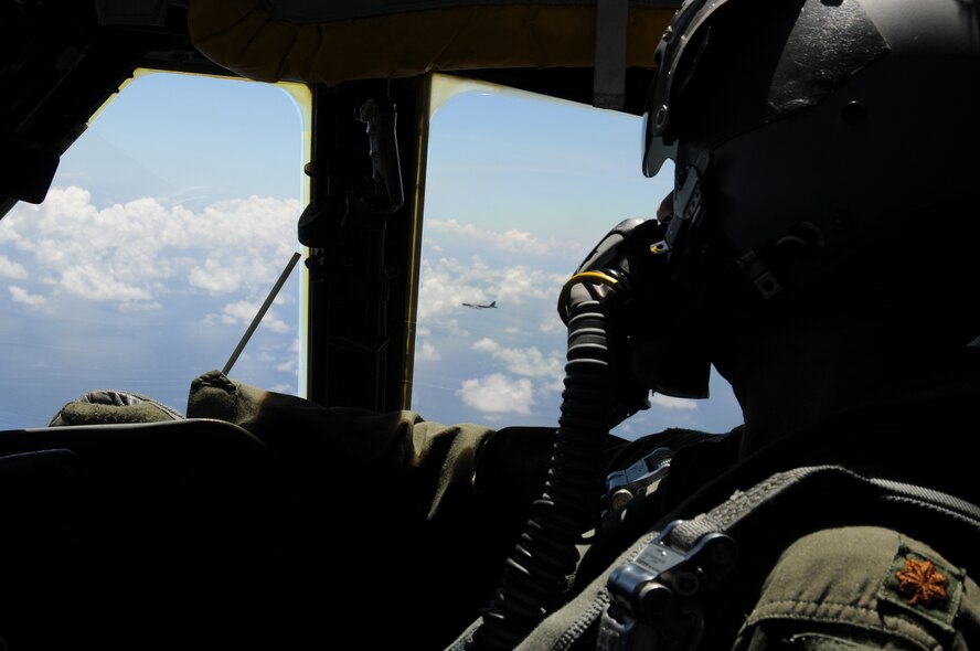 ANDERSEN AIR FORCE BASE, Guam- A instructor-pilot from the 69th Expeditionary Bomb Squadron, Minot Air Force Base, N.D., looks out the window at the other B-52?s in formation preparing to refuel in-flight. (U.S. Air Force photo/ Senior Airman Carlin Leslie)