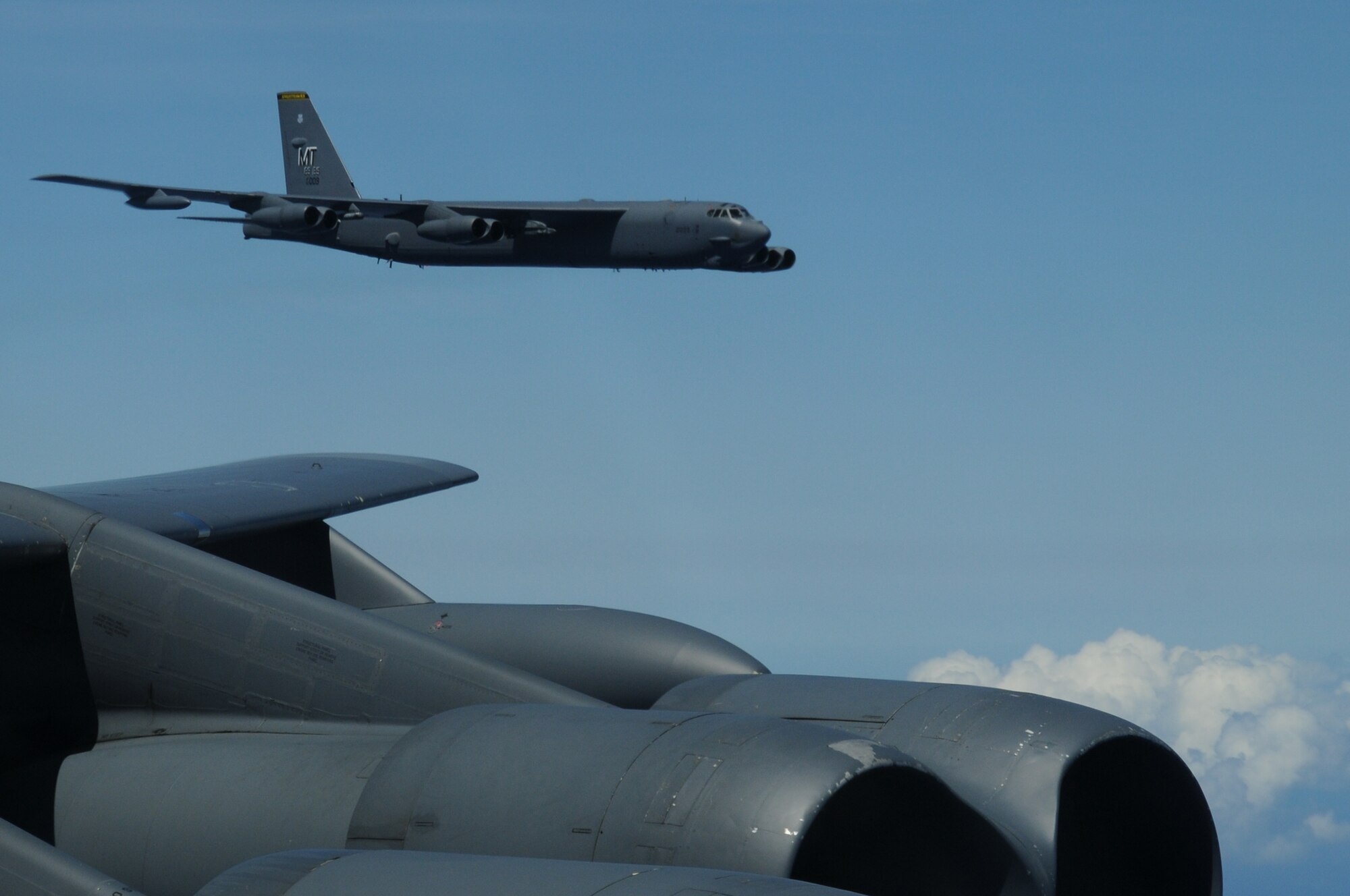ANDERSEN AIR FORCE BASE, Guam- A B-52 Stratofortress from the 69th Expeditionary Bomb Squadron, Minot Air Force Base, N.D., is seen off the left wing while flying in formation with two other B-52's from Minot, March 15. The aircraft are conducting a training mission including a bomb run, in-flight refueling and navigation and radar scenarios.(U.S. Air Force photo/ Senior Airman Carlin Leslie)