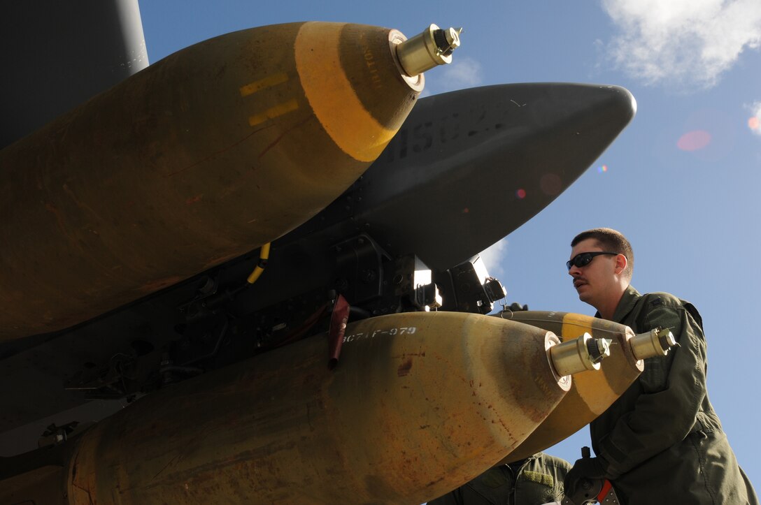 ANDERSEN AIR FORCE BASE, Guam- Capt. Ryan Harvey, 69th Expeditionary Bomb Squadron pilot from Minot Air Force Base, N.D., performs pre-flight inspections on the M117 general purpose bombs before taking off to a training range north of Andersen, March 14. Every weapon is to be inspected and checked for any damage or reasons it could not be deployed over the range during the training mission. (U.S. Air Force photo/ Senior Airman Carlin Leslie)