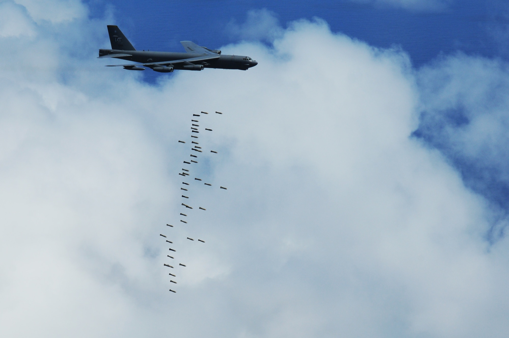 ANDERSEN AIR FORCE BASE, Guam - A B-52 Stratofortress, "The Buff" of the 69th Expeditionary Bomb Squadron from Minot Air Force Base, N.D., releases M117 air-dropped general purpose conventional bombs onto a training range north of Andersen, March 16. The mission also included in-flight refueling, tactical maneuvers, and radar scenarios to test all aspects of the B-52s? capabilities.(U.S. Air Force photo/ Senior Airman Carlin Leslie)

