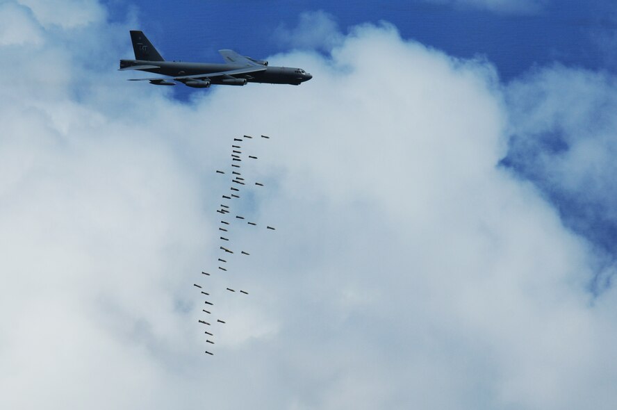 ANDERSEN AIR FORCE BASE, Guam - A B-52 Stratofortress, "The Buff" of the 69th Expeditionary Bomb Squadron from Minot Air Force Base, N.D., releases M117 air-dropped general purpose conventional bombs onto a training range north of Andersen, March 16. The mission also included in-flight refueling, tactical maneuvers, and radar scenarios to test all aspects of the B-52s? capabilities.(U.S. Air Force photo/ Senior Airman Carlin Leslie)

